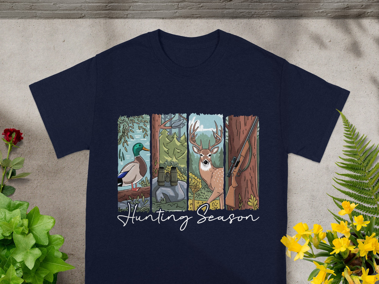Dark blue t-shirt with cartoon duck, deer, binoculars, and rifle with "Hunting Season" text.