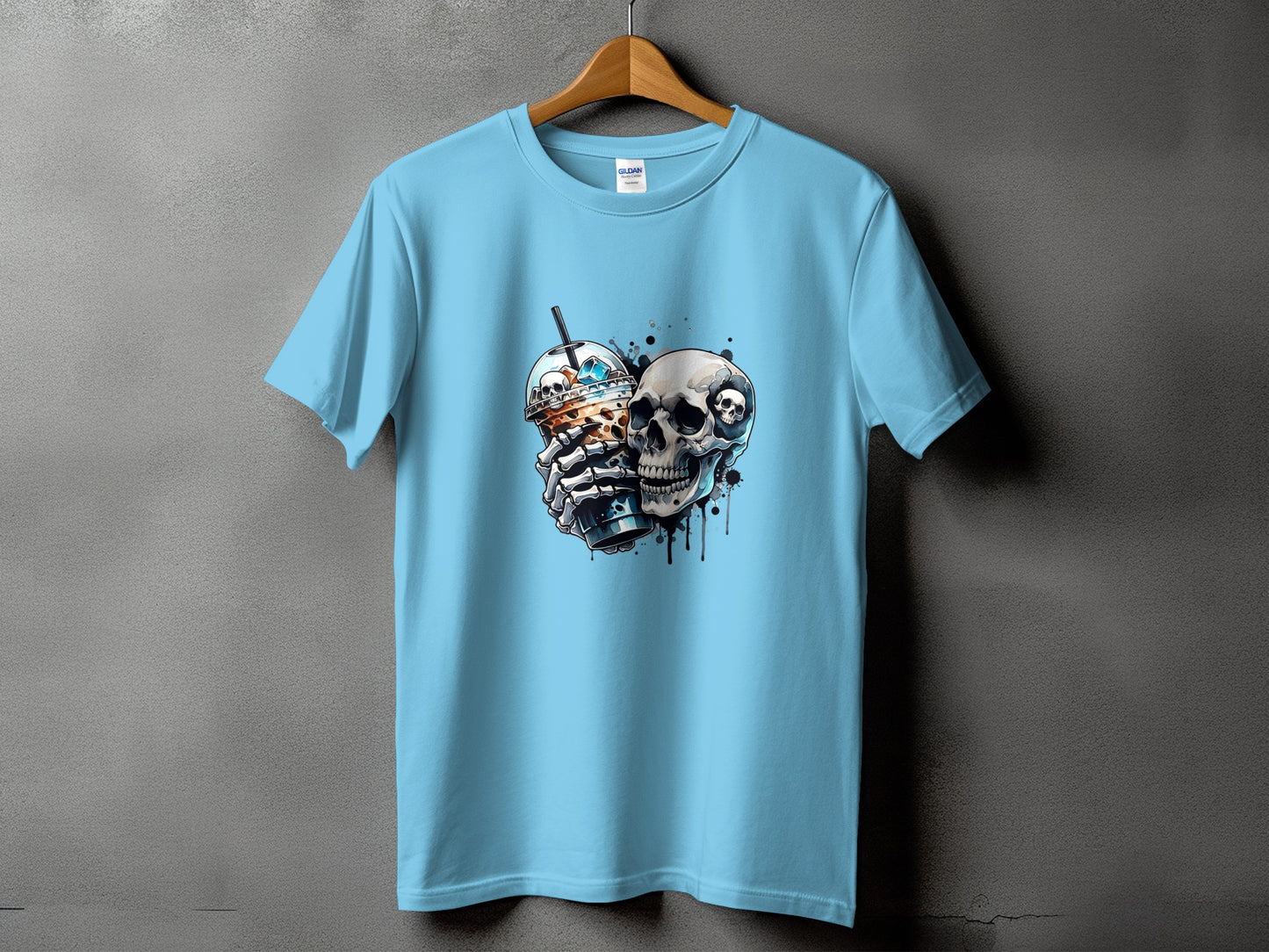 Light blue t-shirt with a graphic of two skulls holding a iced coffee drink.