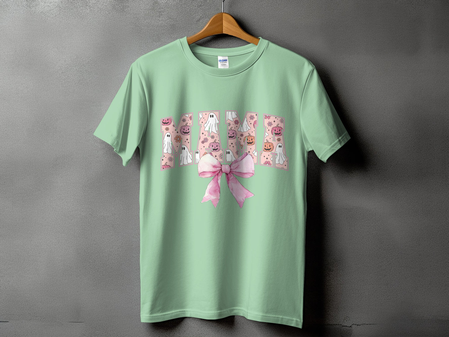 Mint green t-shirt with "Mama" text and Halloween ghosts, pumpkins, and flowers.