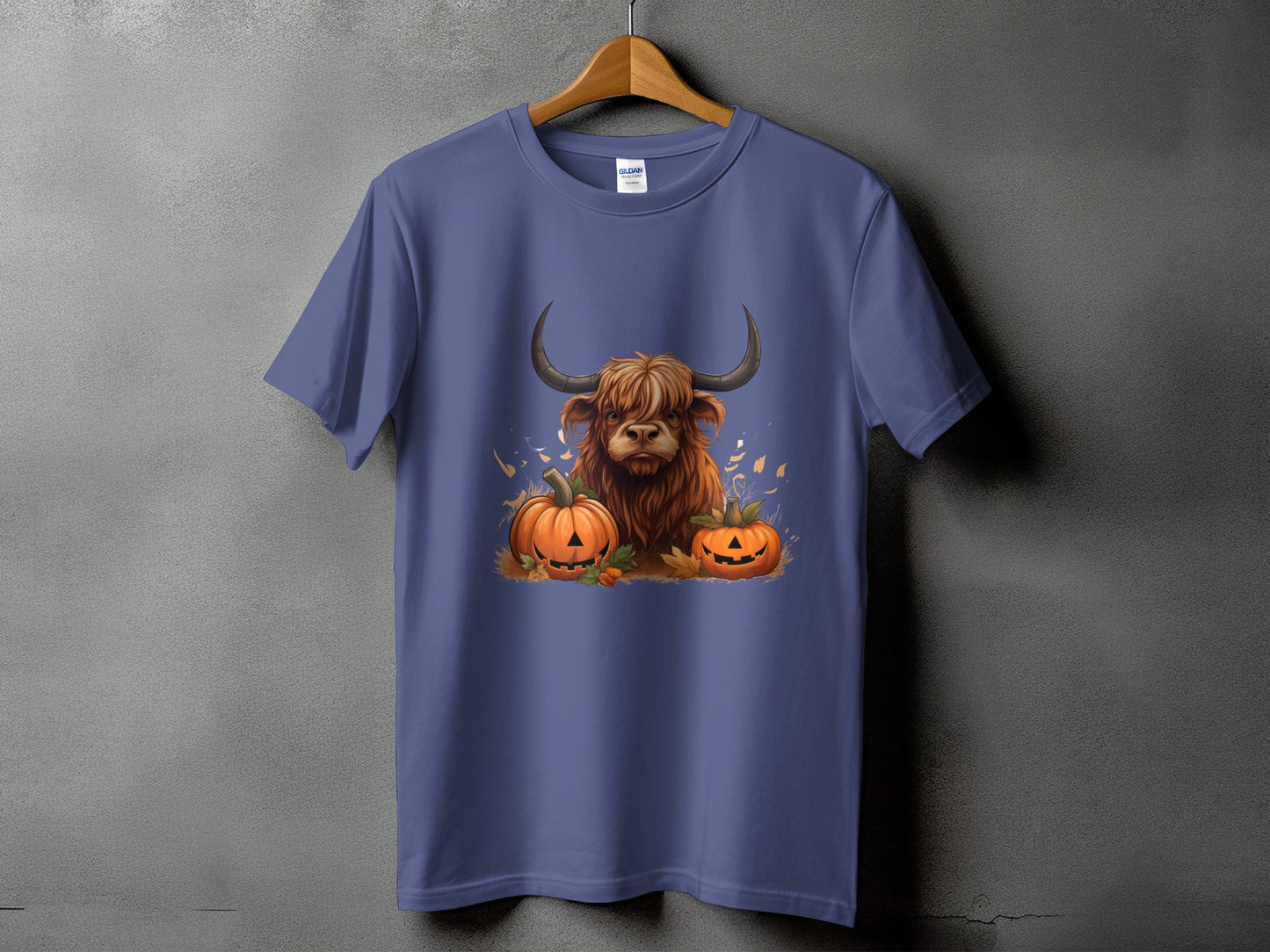 Highland cow and jack-o'-lanterns graphic on a purple t-shirt.