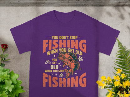 Purple t-shirt with "You Don't Stop Fishing When You Get Old" text and fish graphic.