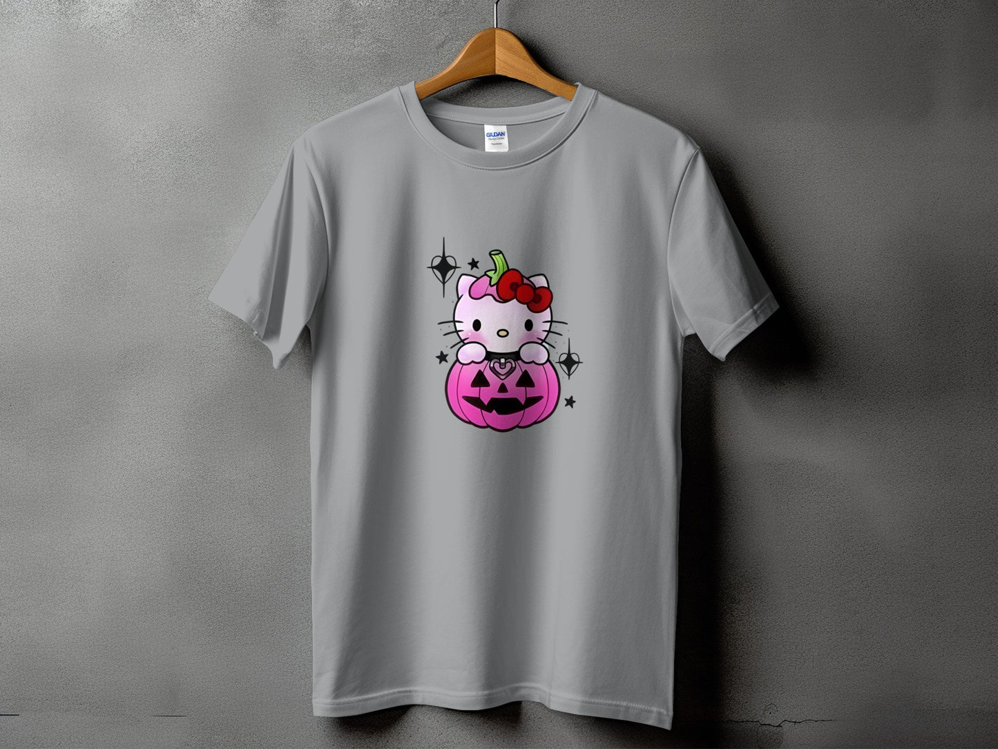 Grey t-shirt with Hello Kitty sitting on a pink pumpkin graphic.