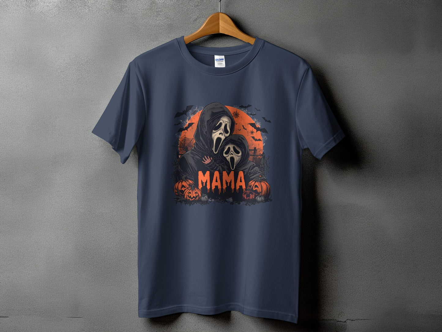 Dark t-shirt with Halloween-themed graphic of ghosts and pumpkins, text reads "MAMA".