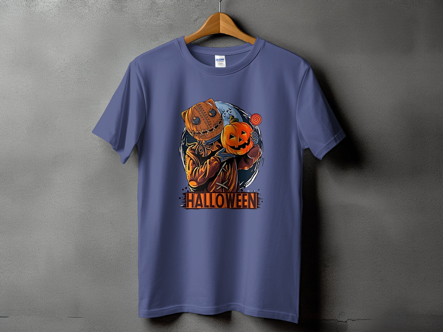 Purple t-shirt with a graphic of a burlap scarecrow holding a pumpkin and a lollipop.