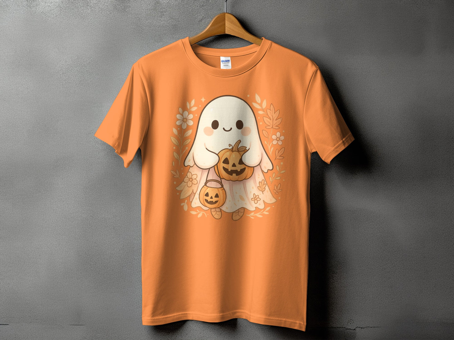 Orange t-shirt with a cute ghost holding pumpkins and surrounded by fall leaves.