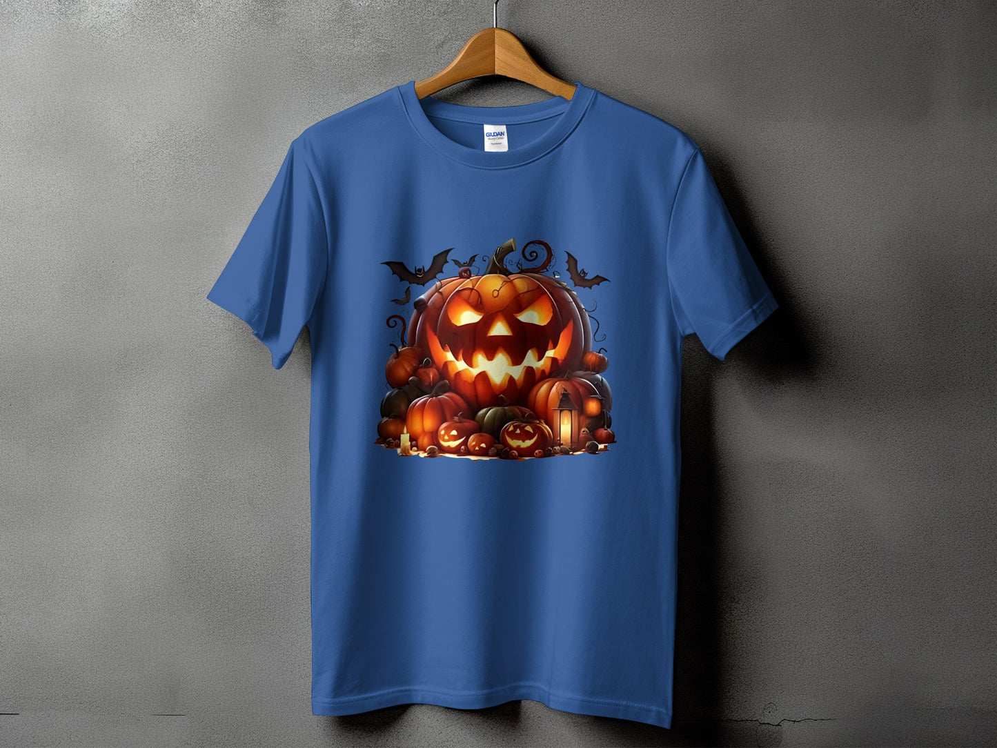 Blue t-shirt with a Halloween pumpkin pile graphic and bats.