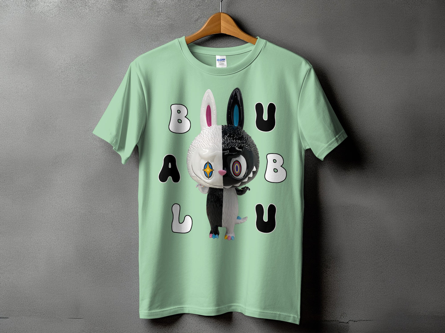 Mint green t-shirt with a black and white half-and-half character and large letters.