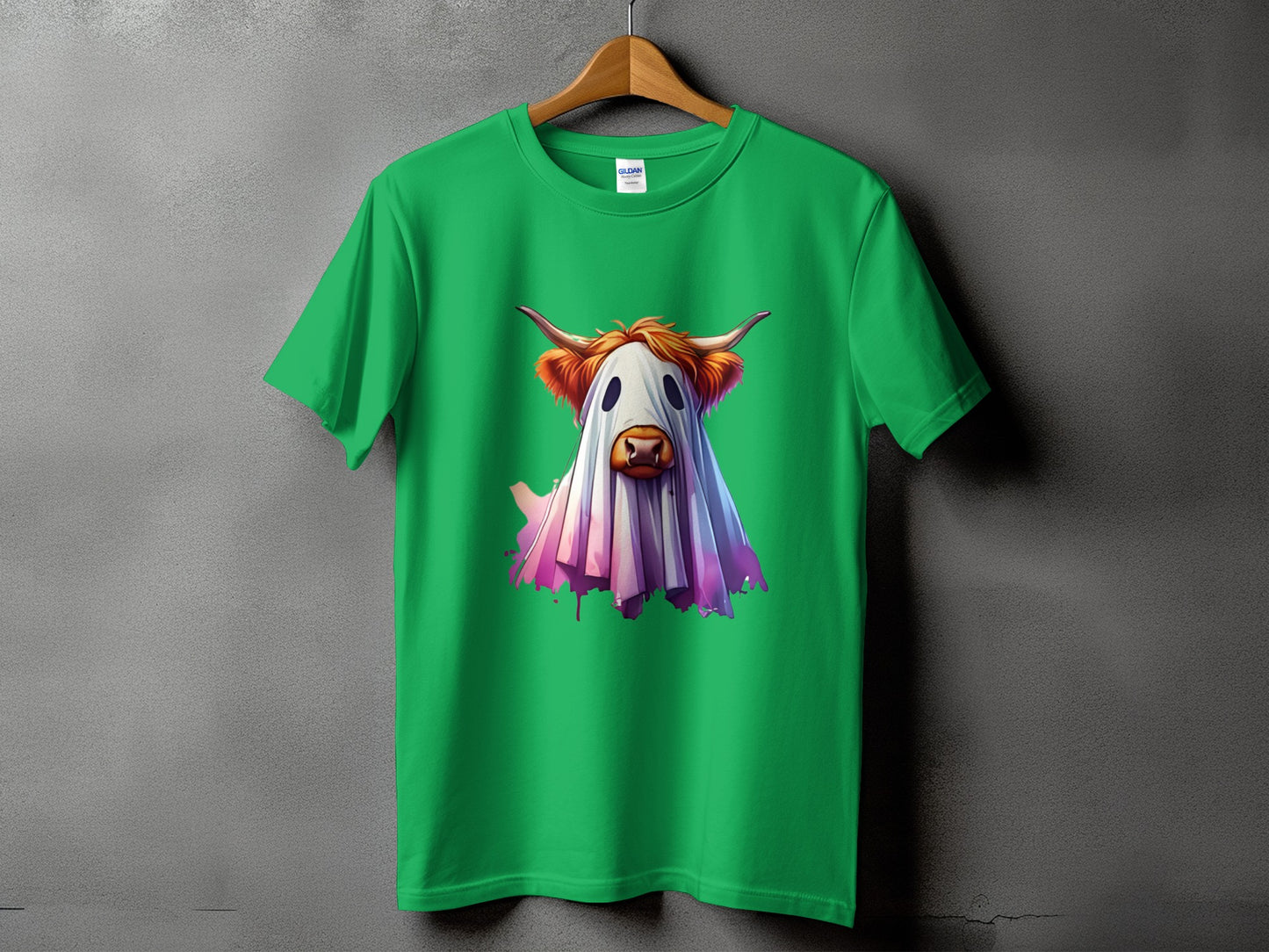 Green t-shirt with a Highland cow dressed as a ghost graphic.