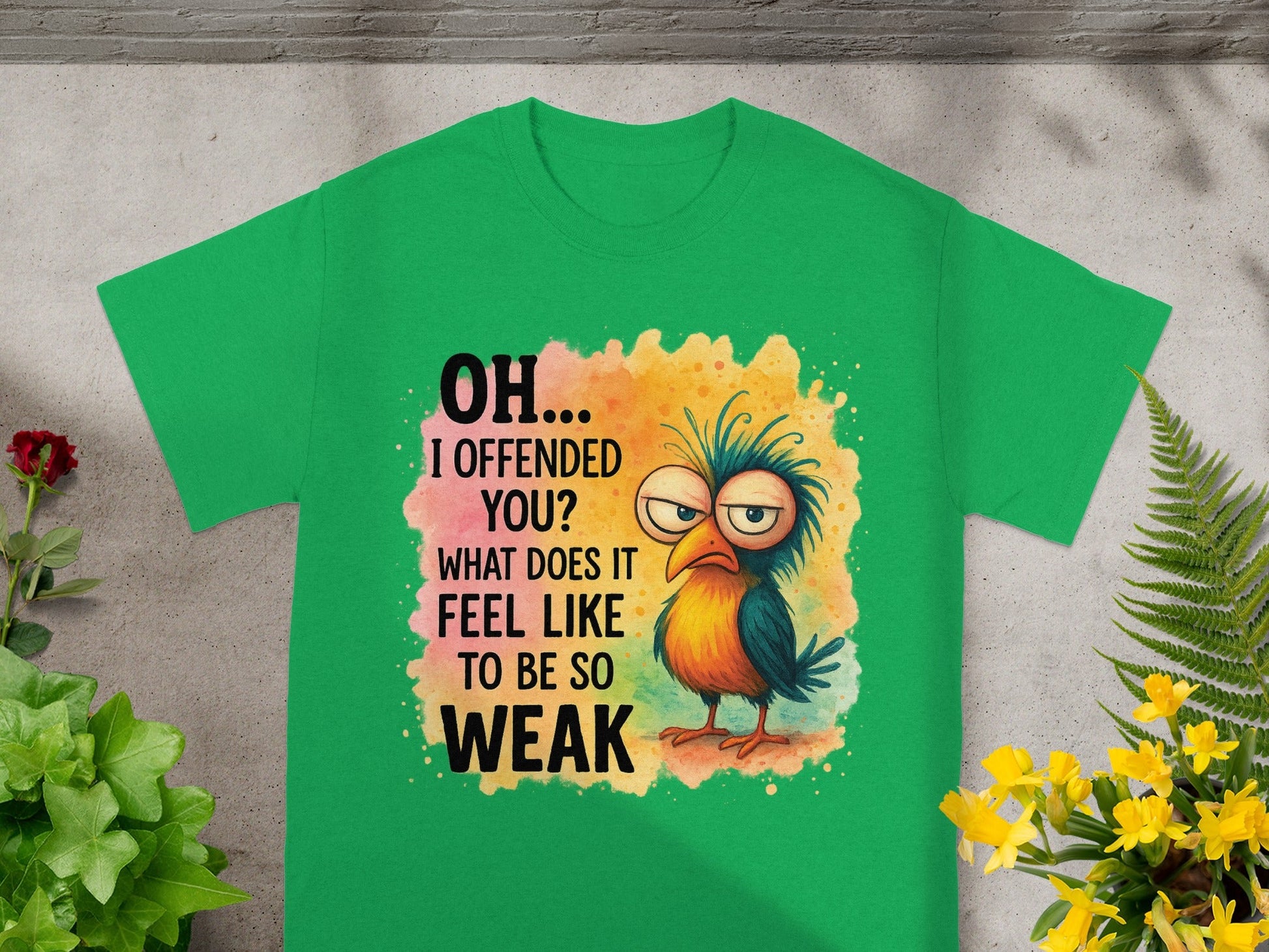 Green t-shirt with cartoon bird and text "OH... I OFFENDED YOU? WHAT DOES IT FEEL LIKE TO BE SO WEAK".