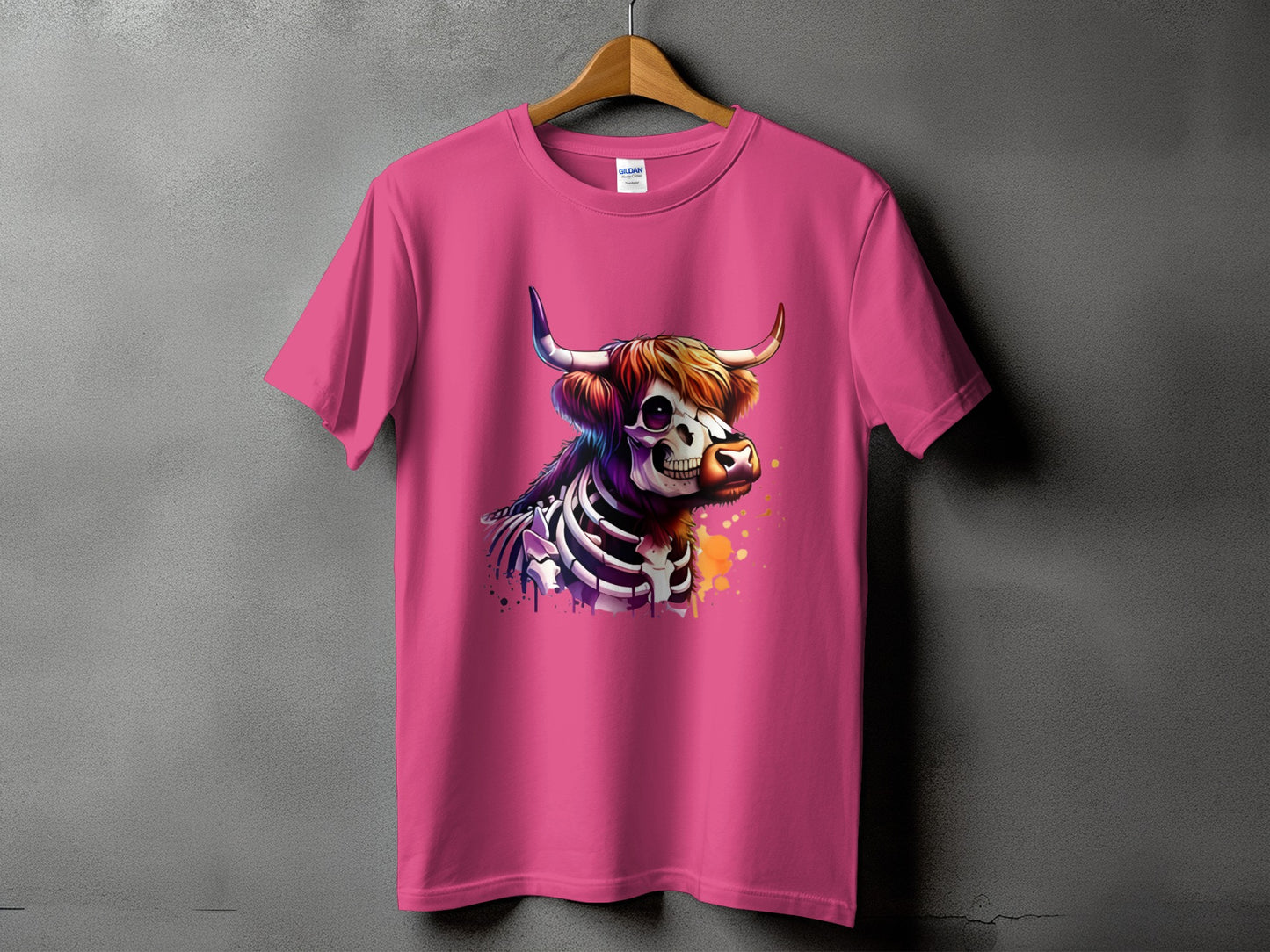 Pink t-shirt with a watercolor skeleton cow graphic.