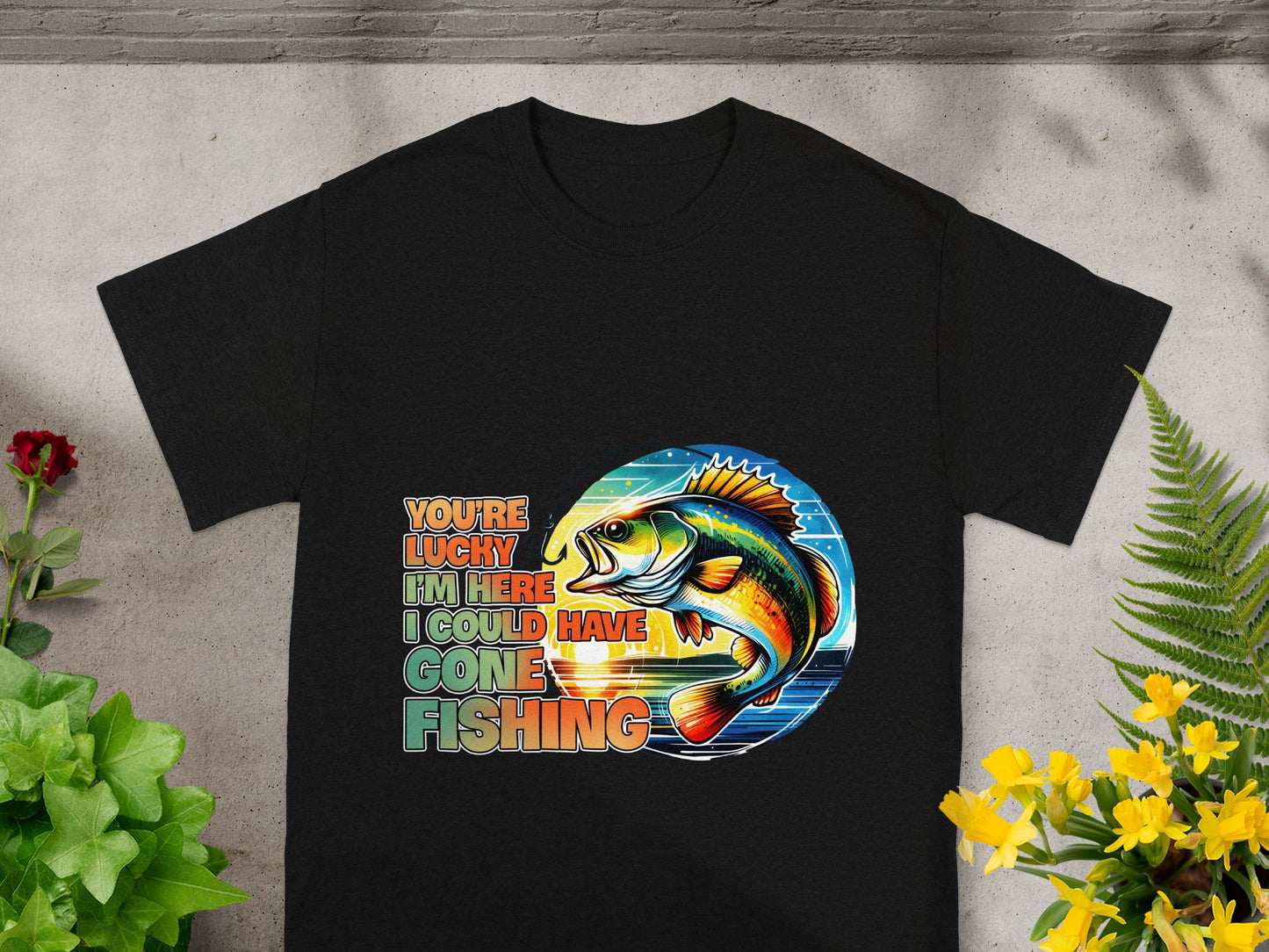 Black t-shirt with multi-colored text and fish graphic: "You're lucky I'm here I could have gone fishing."