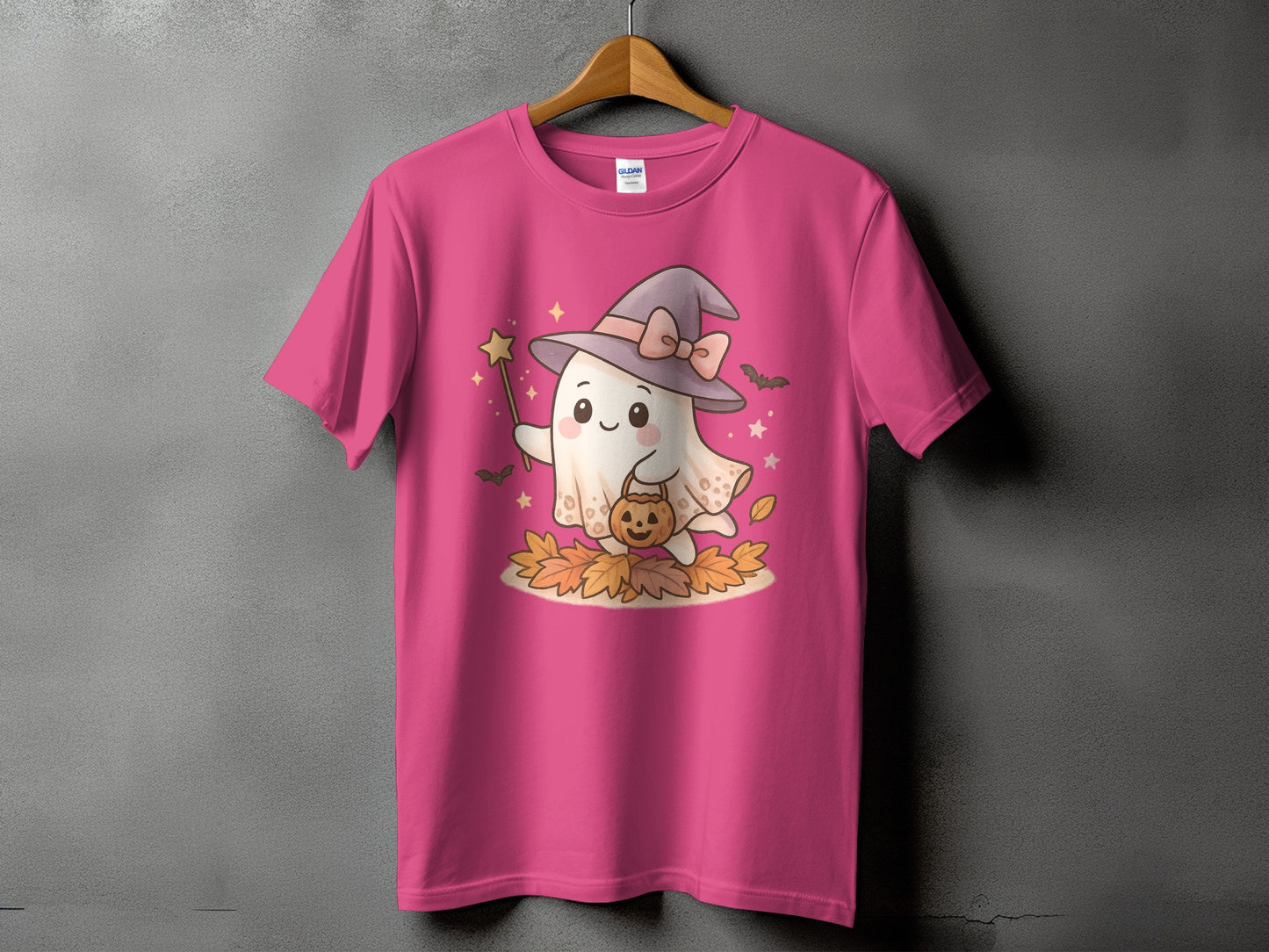 Pink t-shirt with a cute ghost wearing a witch hat and holding a pumpkin.