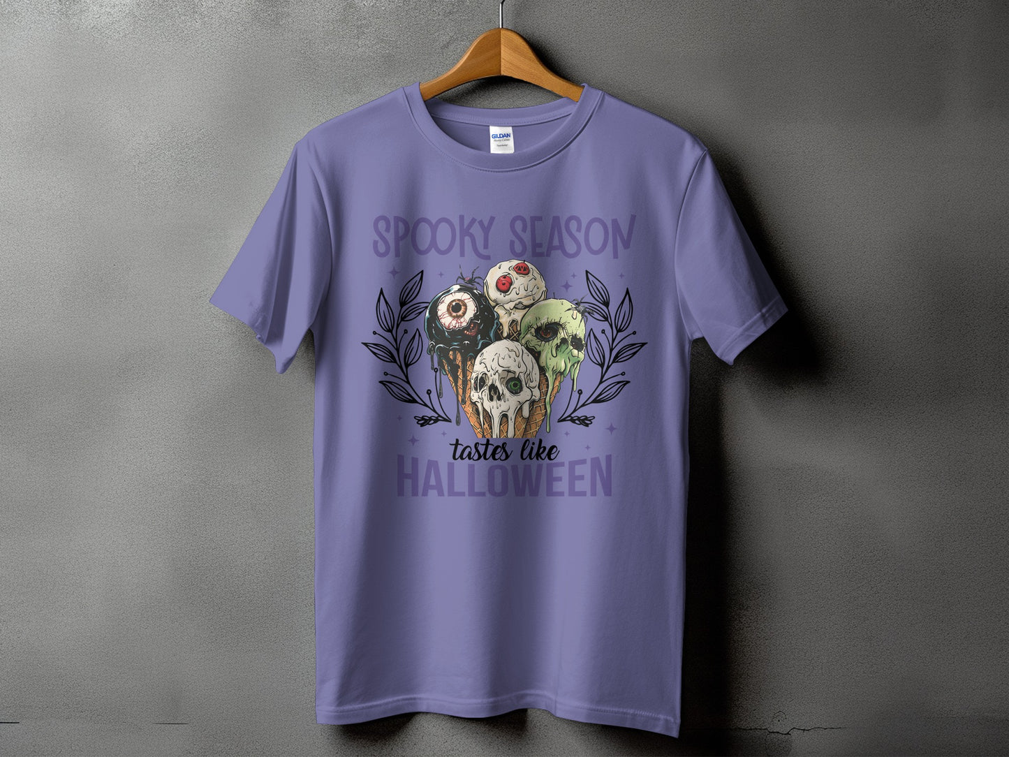 Purple t-shirt with "Spooky season tastes like Halloween" text and spooky ice cream cone graphic.