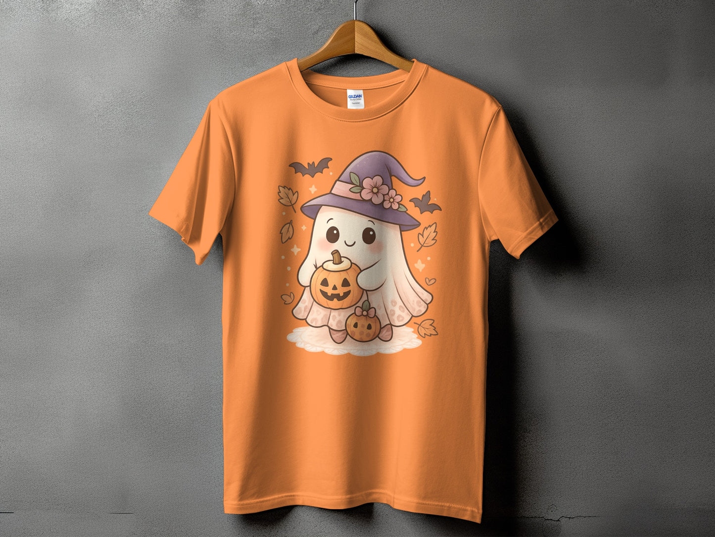 Orange t-shirt with a cute ghost character holding pumpkins.