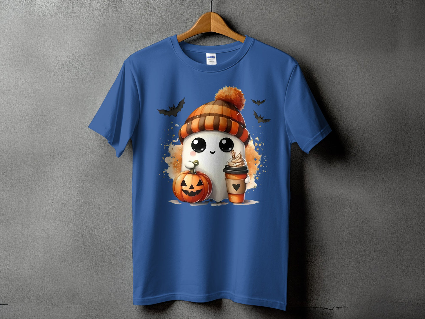 Blue t-shirt with a cartoon ghost, pumpkin, and coffee cup graphic.