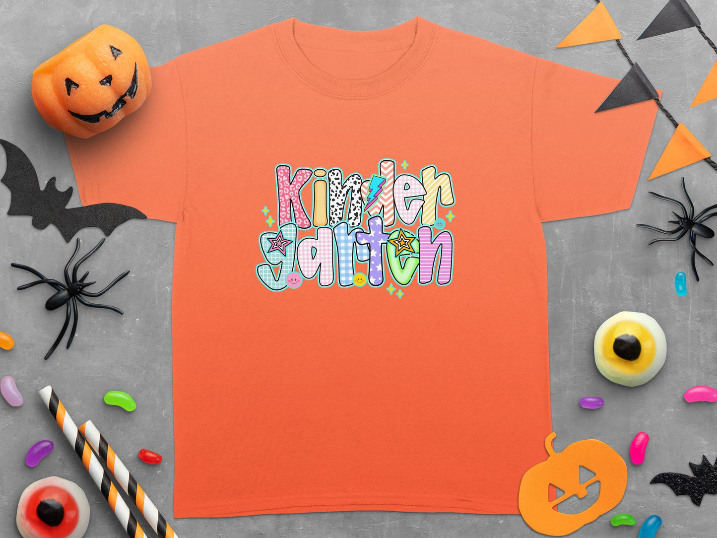 Orange t-shirt with "Kindergarten" text and Halloween decorations.