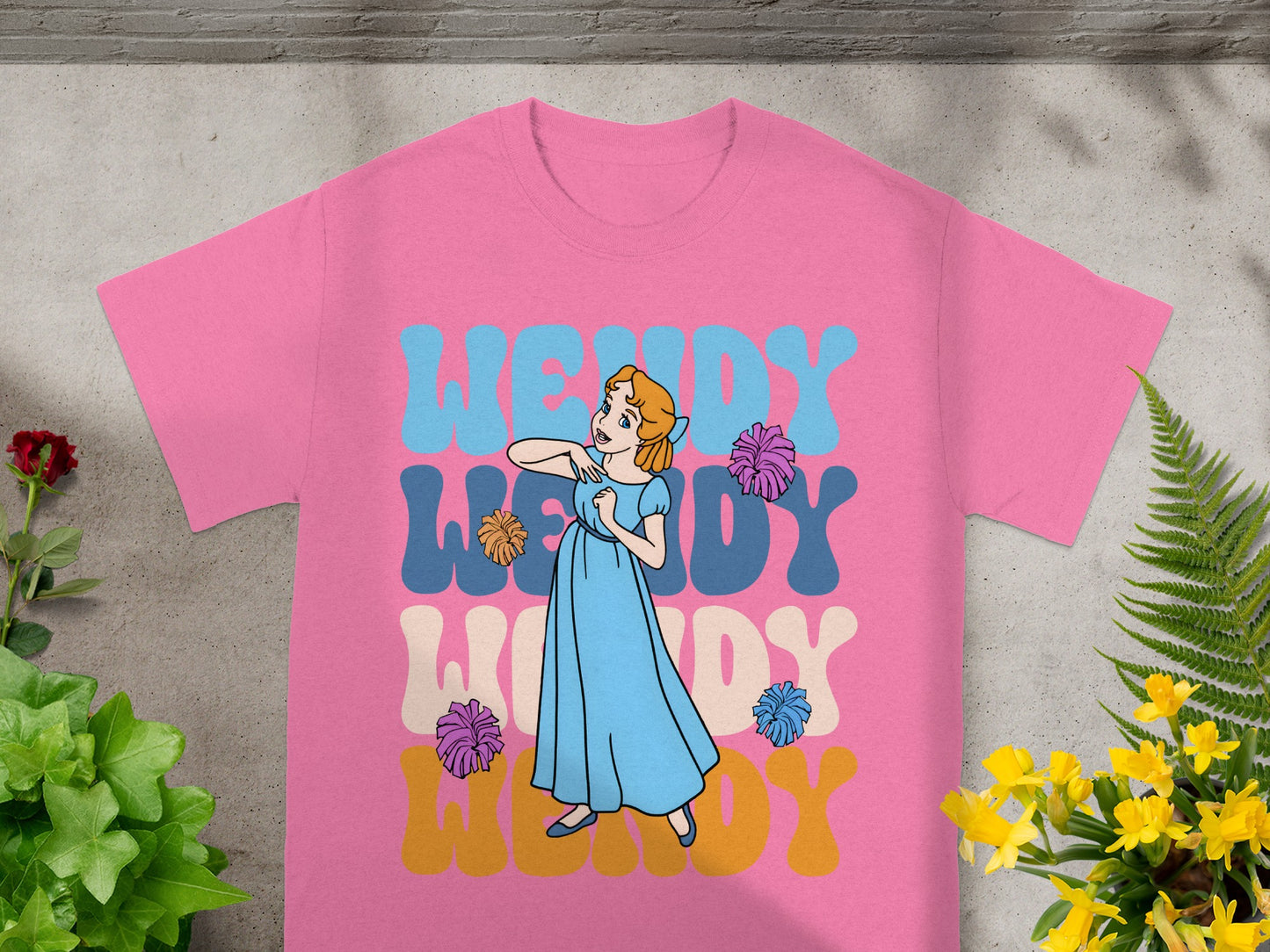 Pink t-shirt with Wendy in wavy letters and cartoon illustration.
