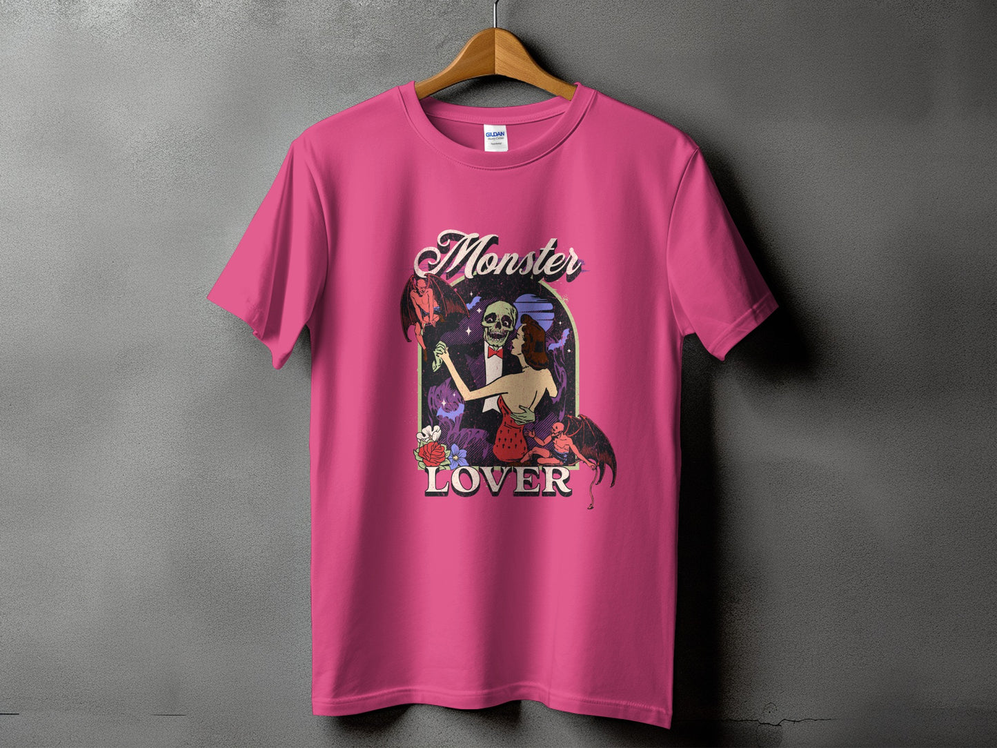 Pink t-shirt with "Monster Lover" text and a gothic illustration of a skeleton and a woman.