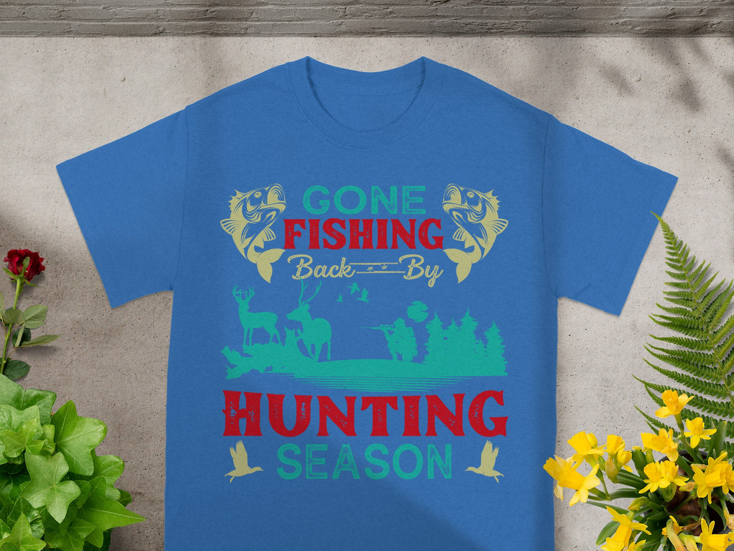 Blue t-shirt with "Gone Fishing Back By Hunting Season" text and outdoor graphics.