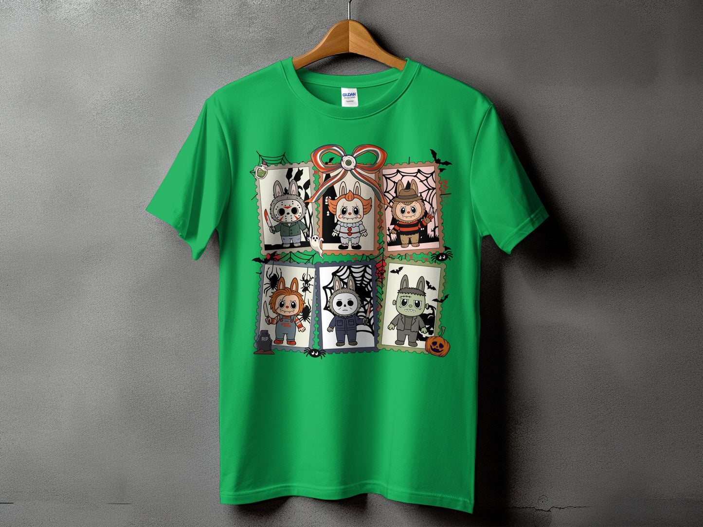 Green t-shirt with six Halloween-themed cartoon horror characters in stamp-like frames.