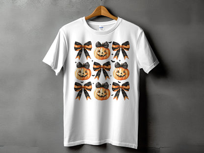 White t-shirt with a pattern of pumpkins and black and orange bows.
