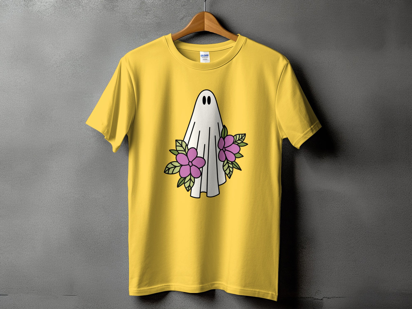 Yellow t-shirt with a white ghost and purple flowers graphic.
