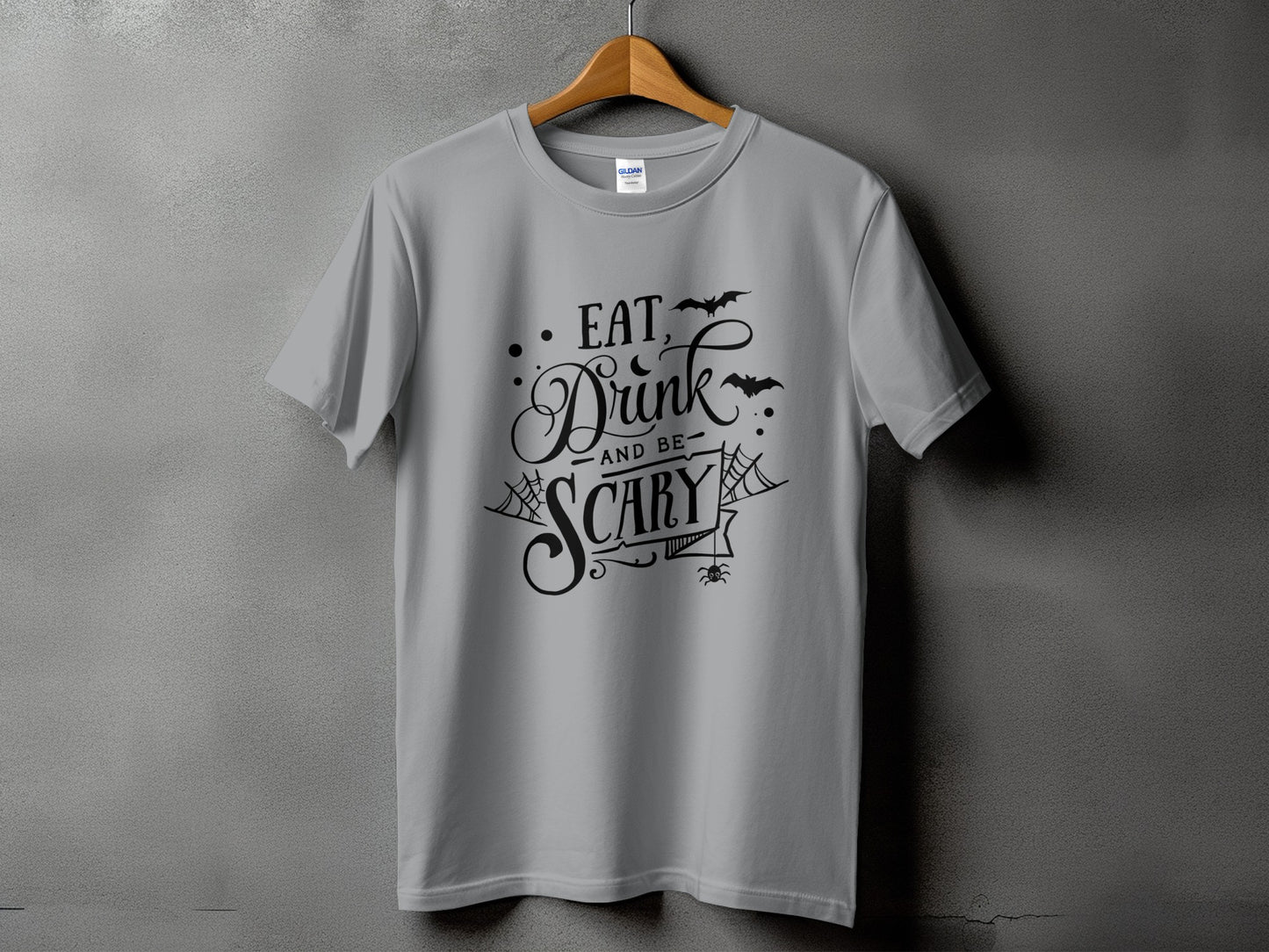 Grey t-shirt with black text that reads "Eat, Drink and be Scary" with bats.