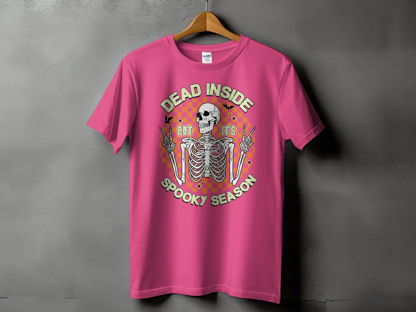 Pink t-shirt with skeleton graphic and text "DEAD INSIDE BUT IT'S SPOOKY SEASON".