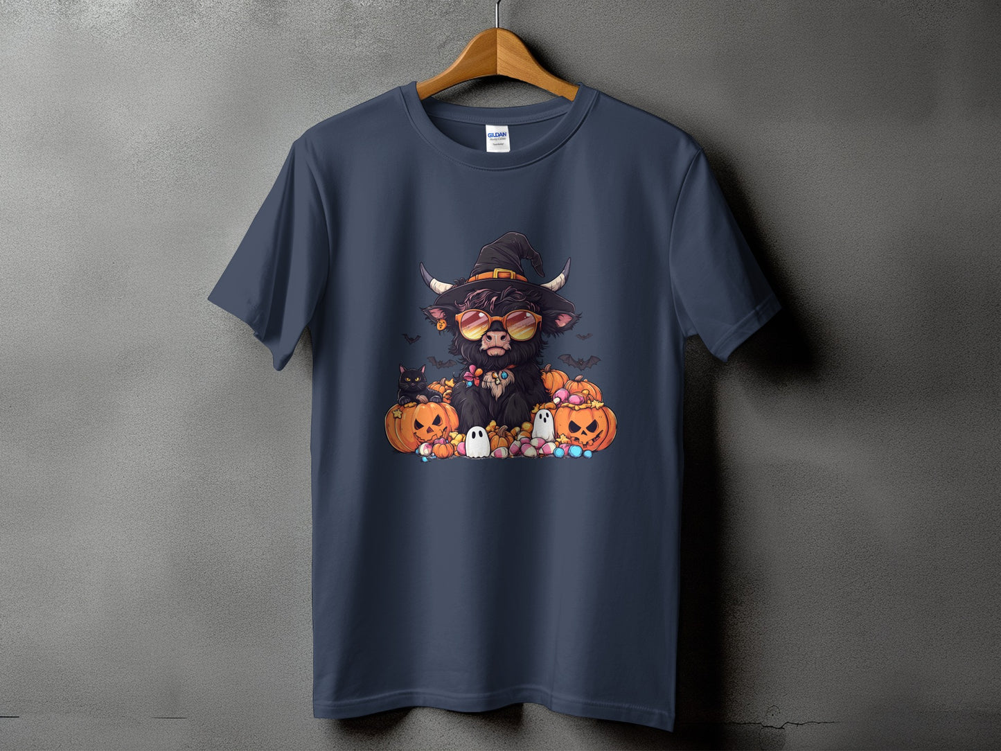 Dark blue t-shirt featuring a Highland cow in a witch hat with pumpkins and ghosts.