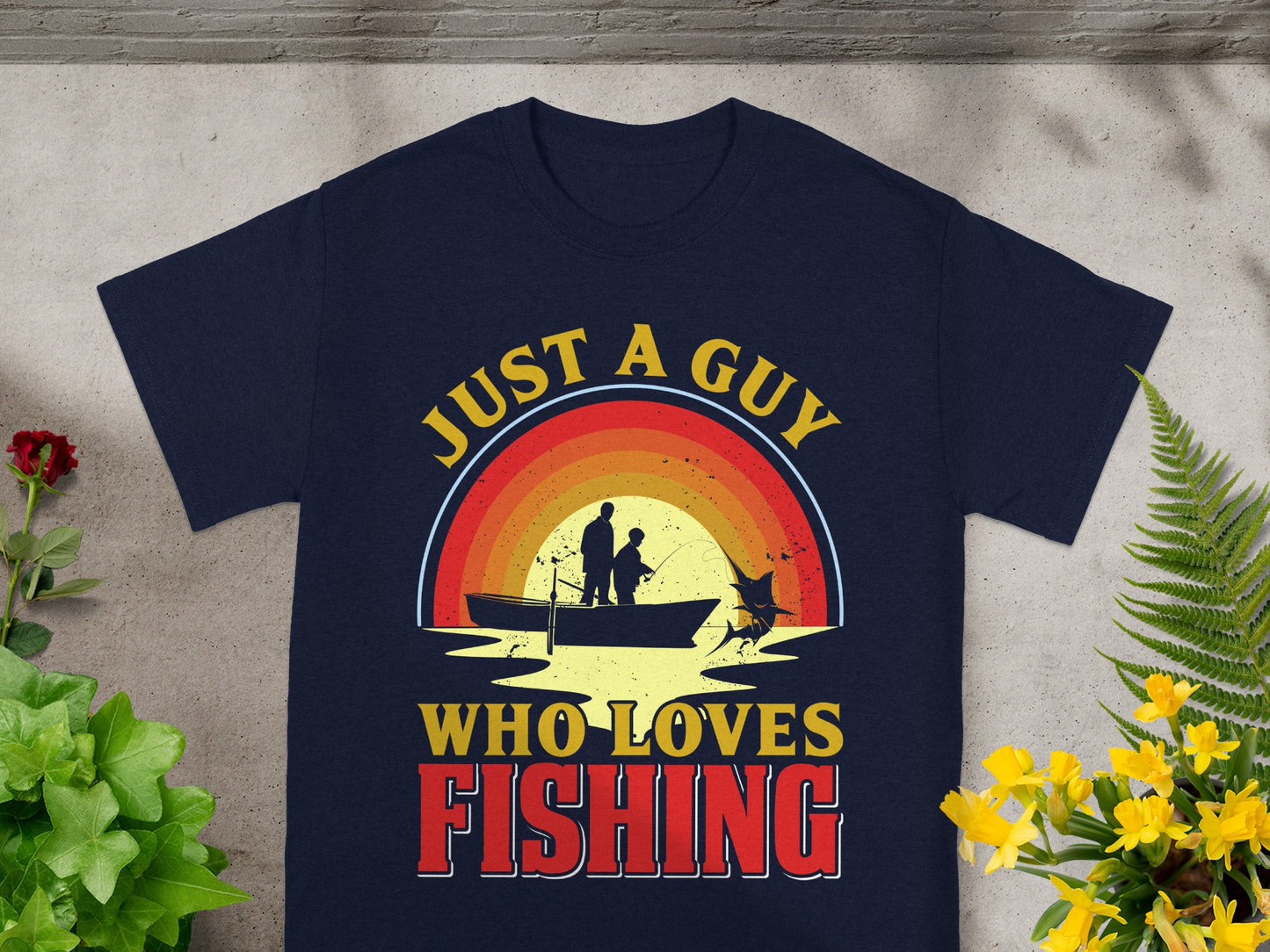 Navy t-shirt with retro fishing graphic and text saying "JUST A GUY WHO LOVES FISHING".