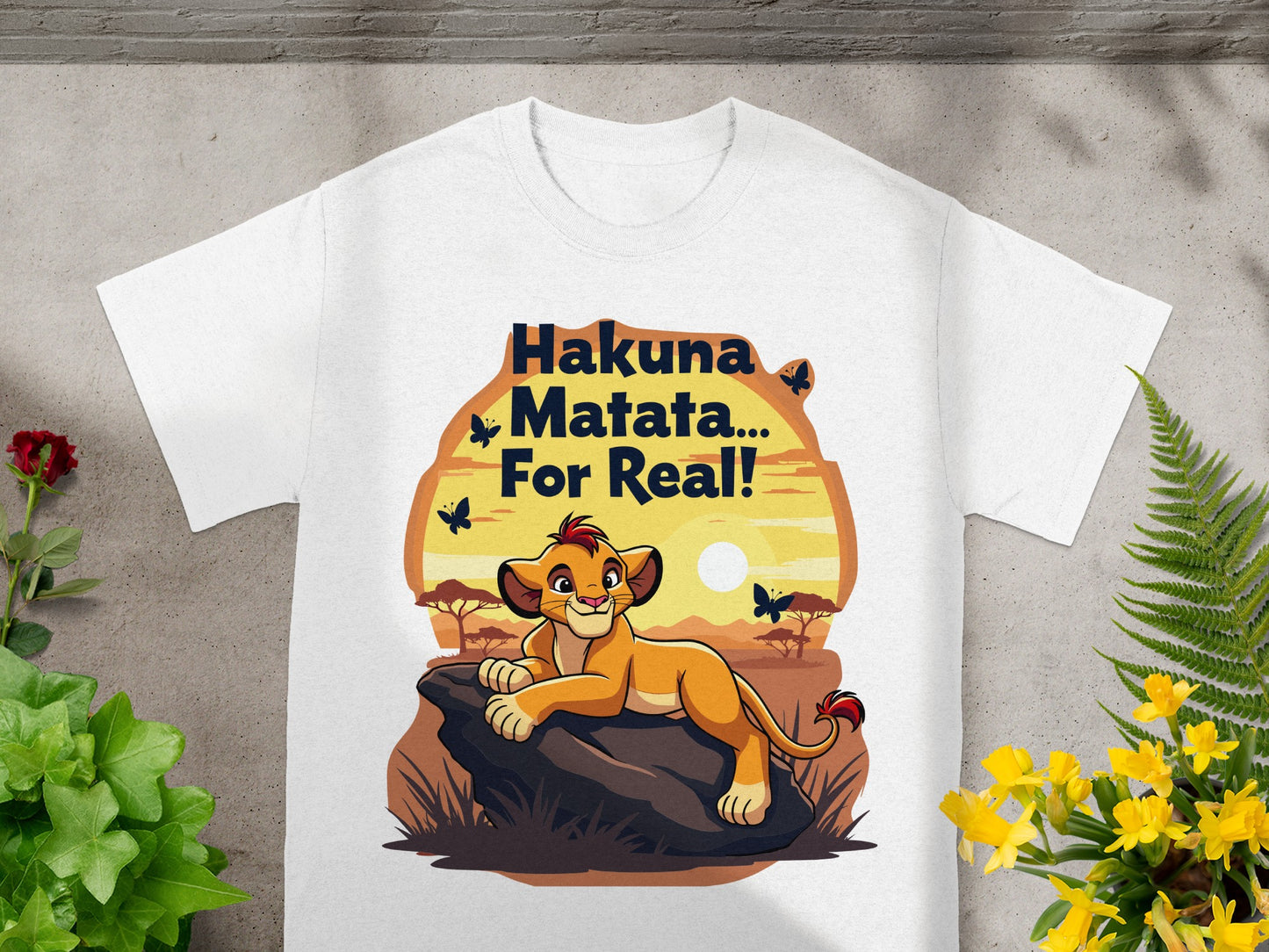 White t-shirt with "Hakuna Matata... For Real!" and Simba resting on a rock.