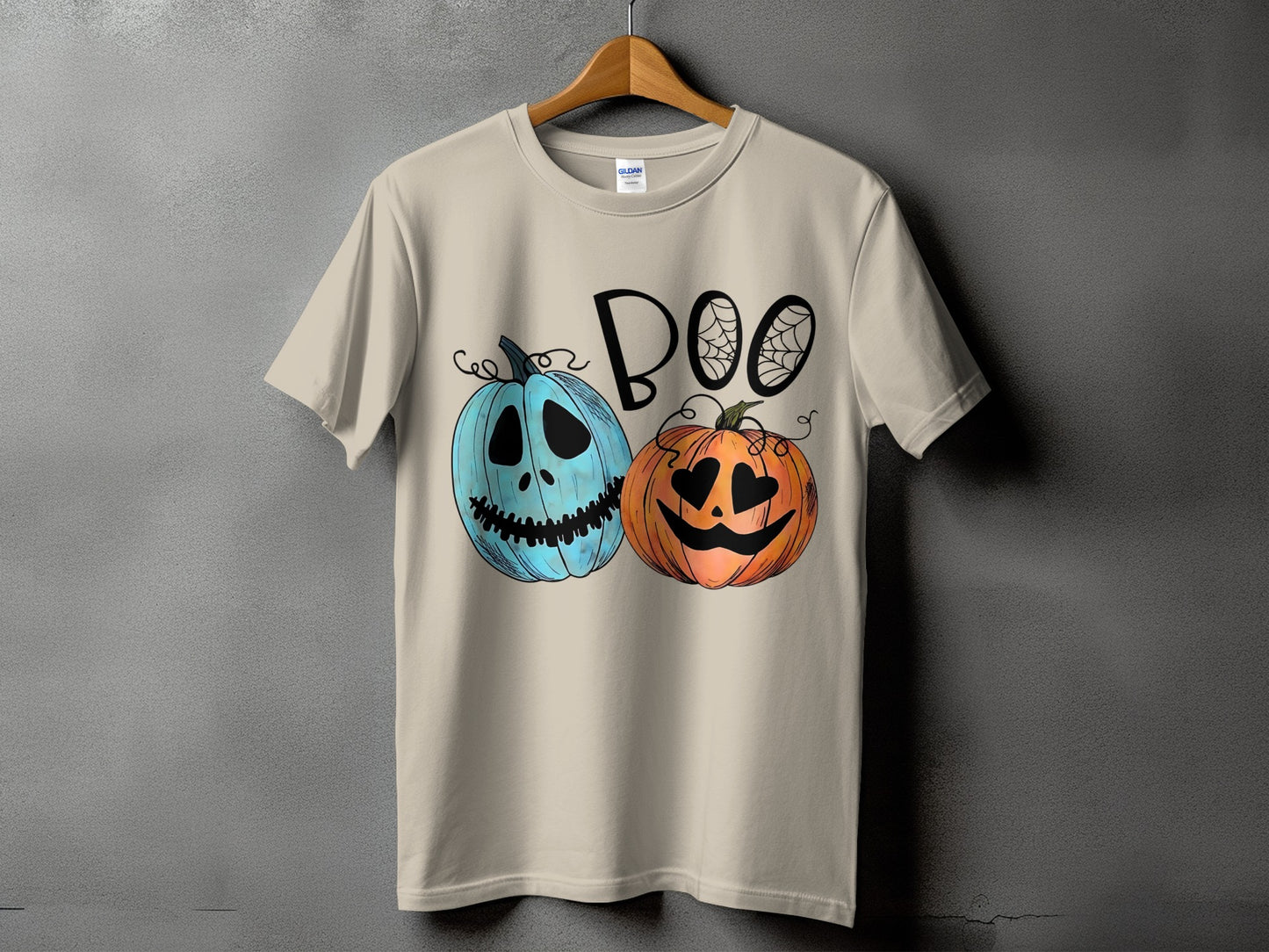Light brown t-shirt with "BOO" text and two cartoon pumpkins.