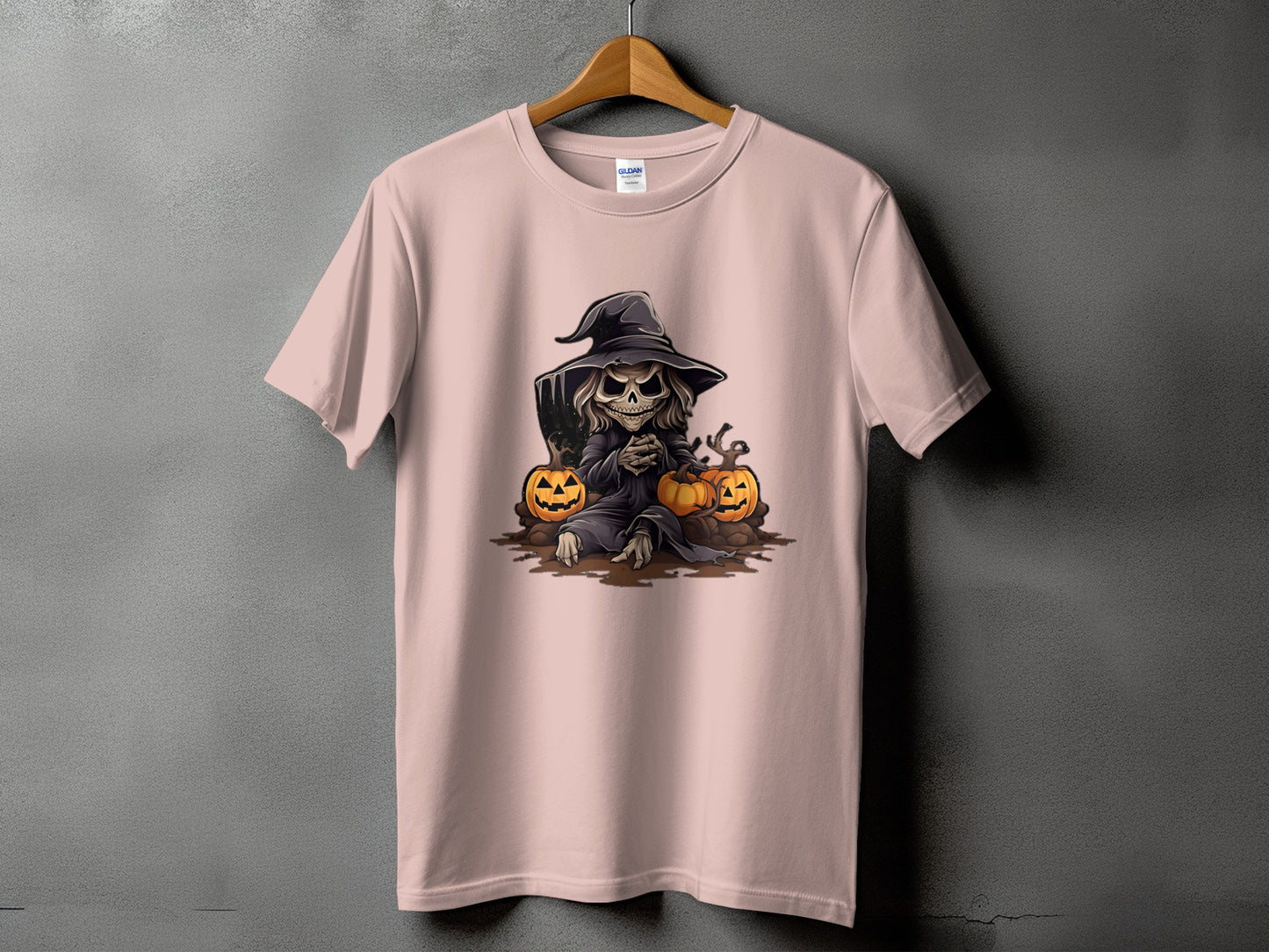 Grim reaper with pumpkins and tombstone graphic on a pink t-shirt.
