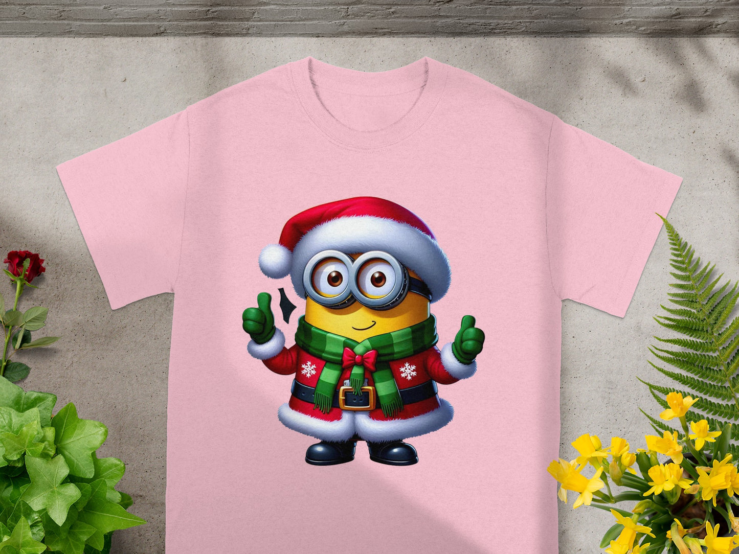 Minion in Santa hat and jacket with green scarf on pink t-shirt.