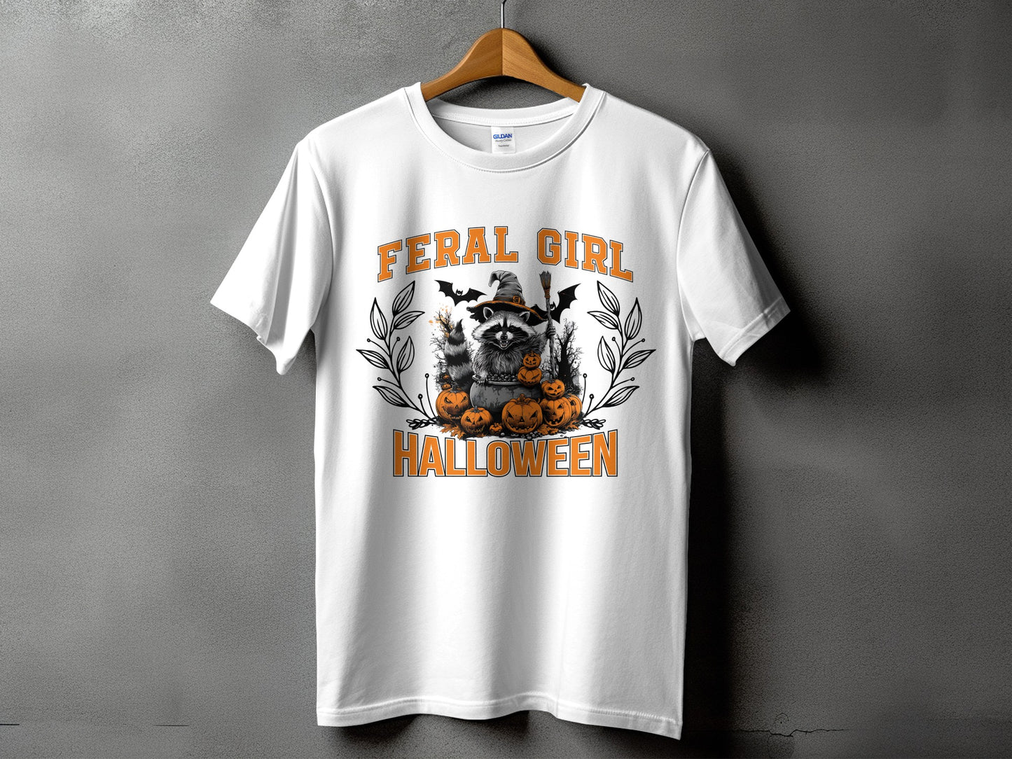 White t-shirt with "FERAL GIRL HALLOWEEN" text and a raccoon witch with pumpkins.