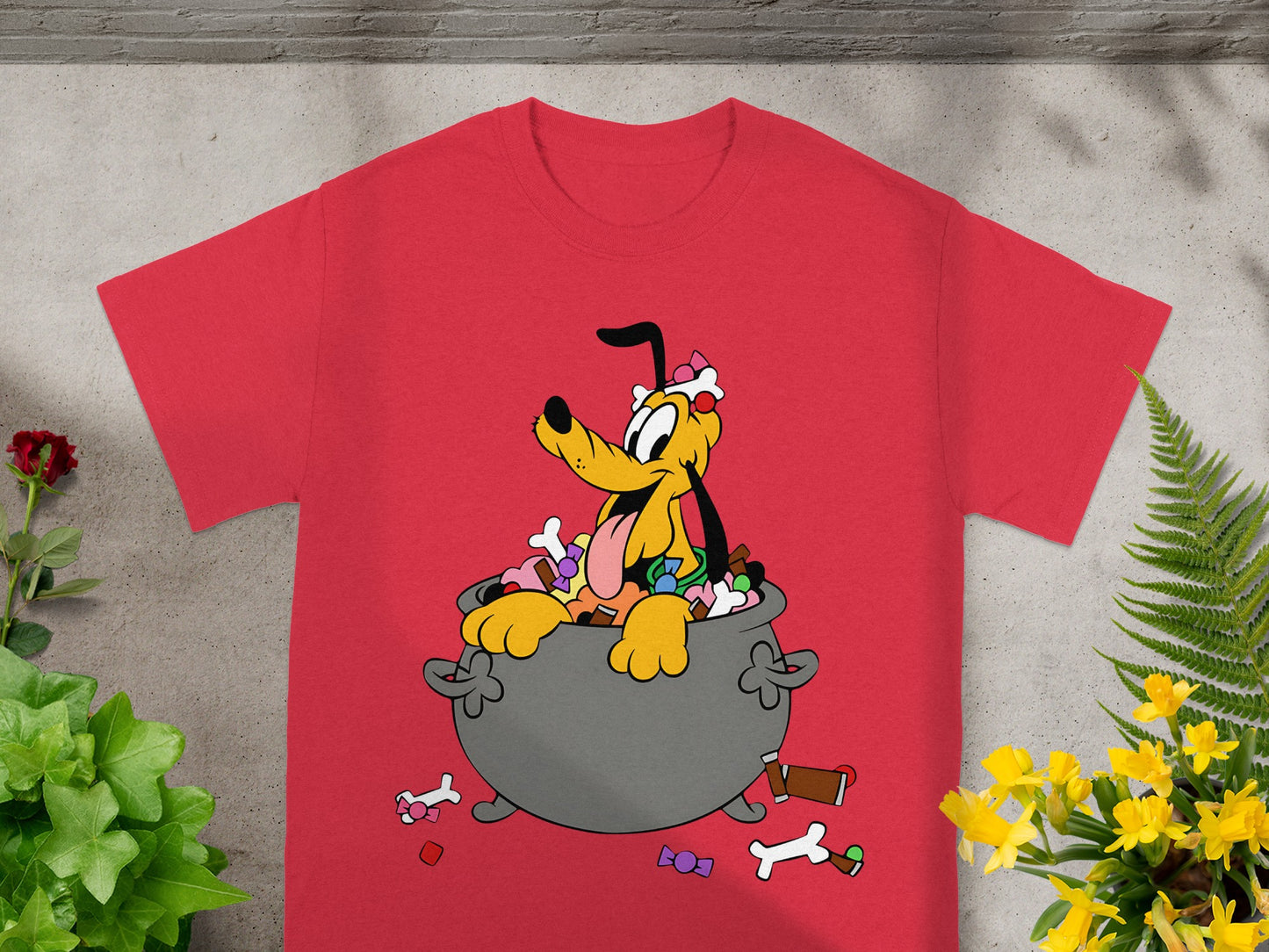 Red t-shirt with cartoon Pluto sitting in a cauldron of candy.
