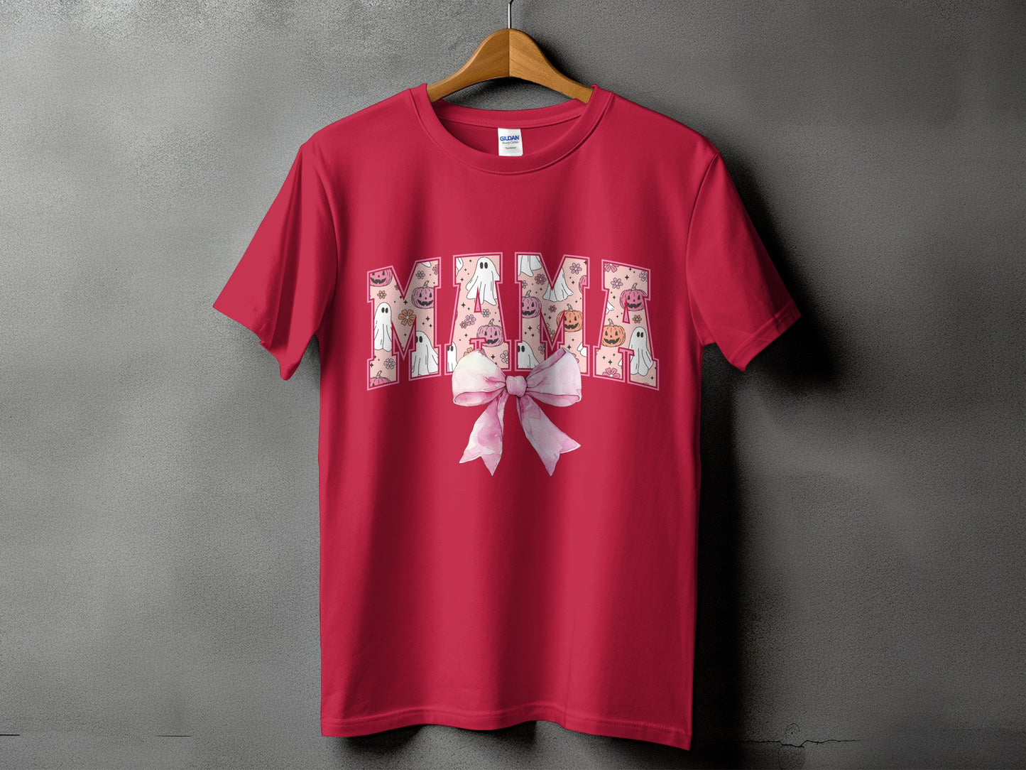 Red t-shirt with "MAMA" in Halloween-themed letters and a pink bow.