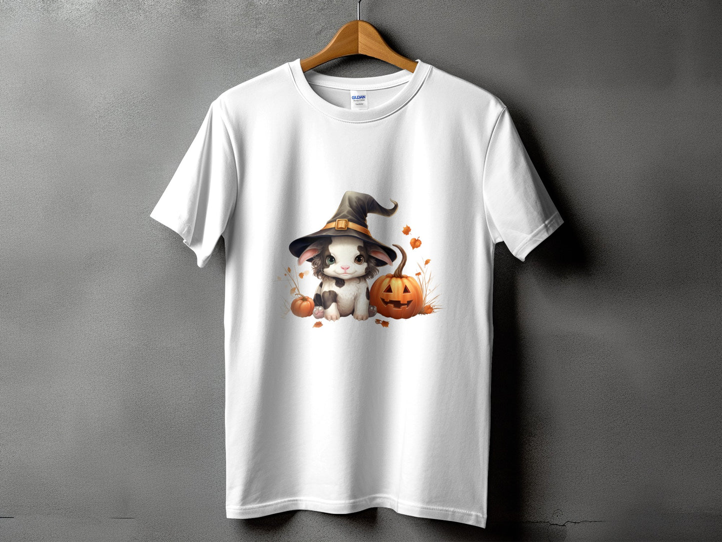 White t-shirt with a cute cartoon cat wearing a witch hat, pumpkins, and autumn leaves.