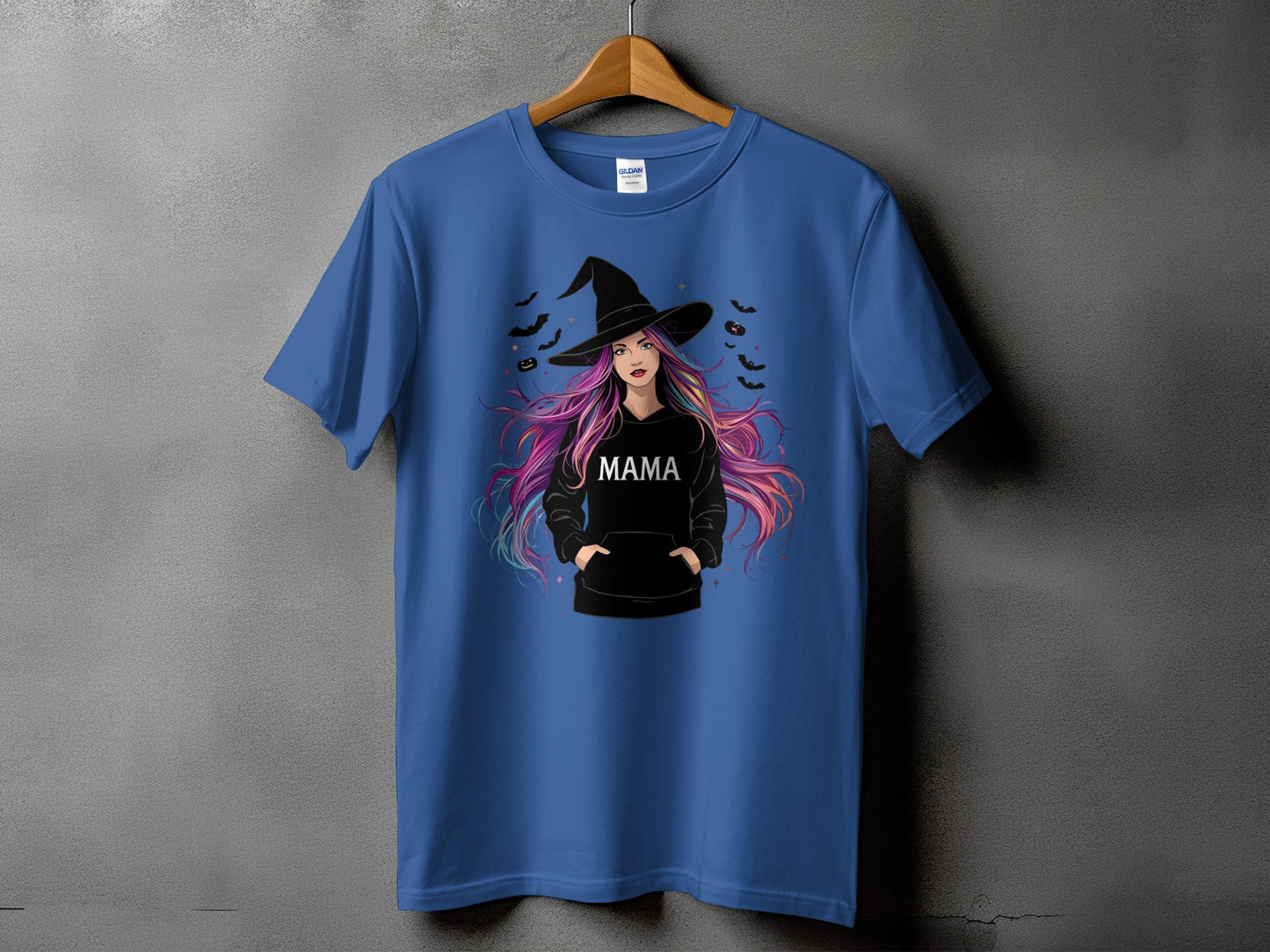 Blue t-shirt with a witch graphic wearing a black hat and hoodie with "MAMA" text.