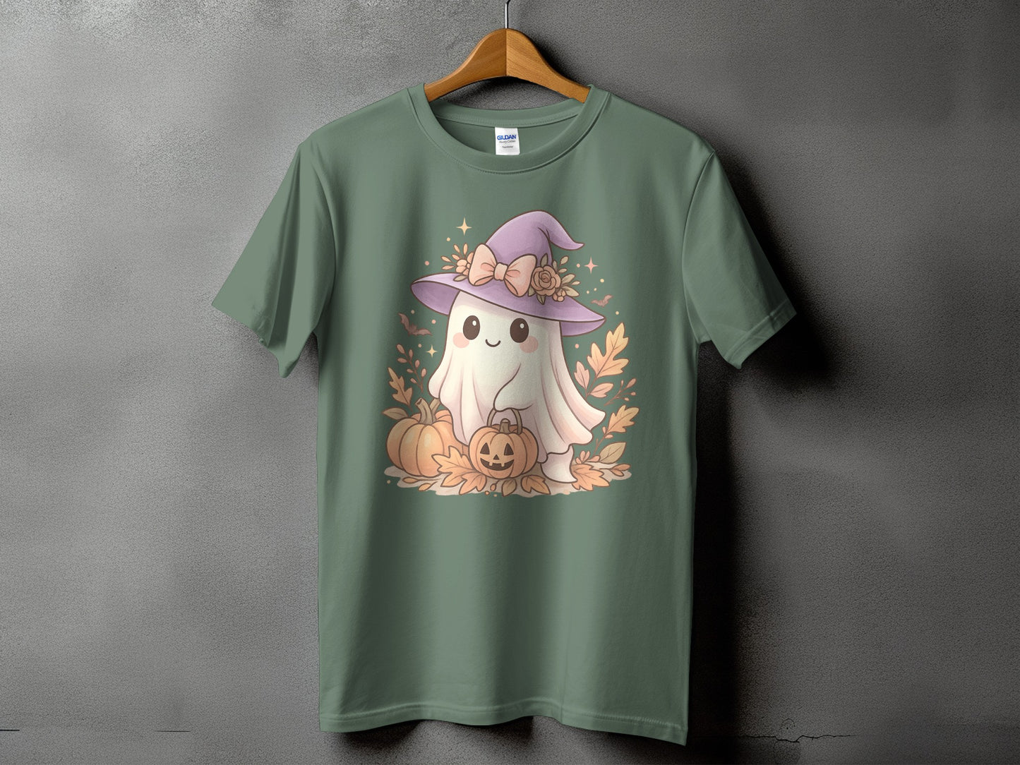 Green t-shirt with a cute ghost wearing a witch hat holding pumpkins.