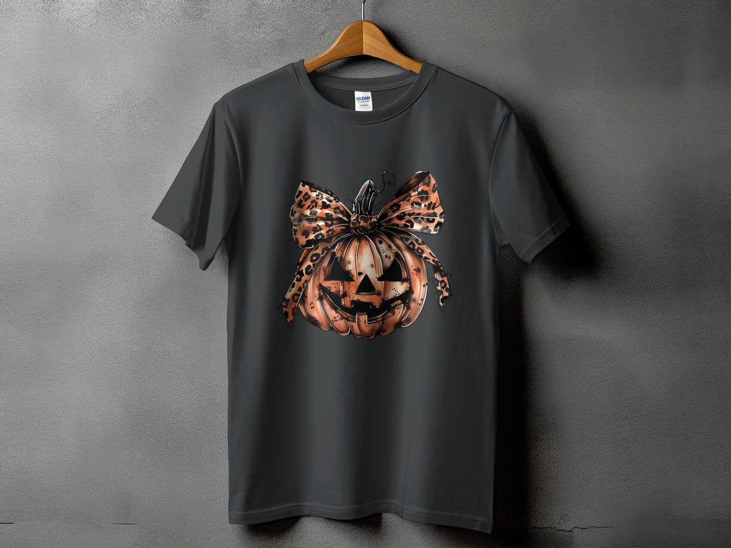 Dark gray t-shirt with a Halloween pumpkin graphic and leopard print bow.