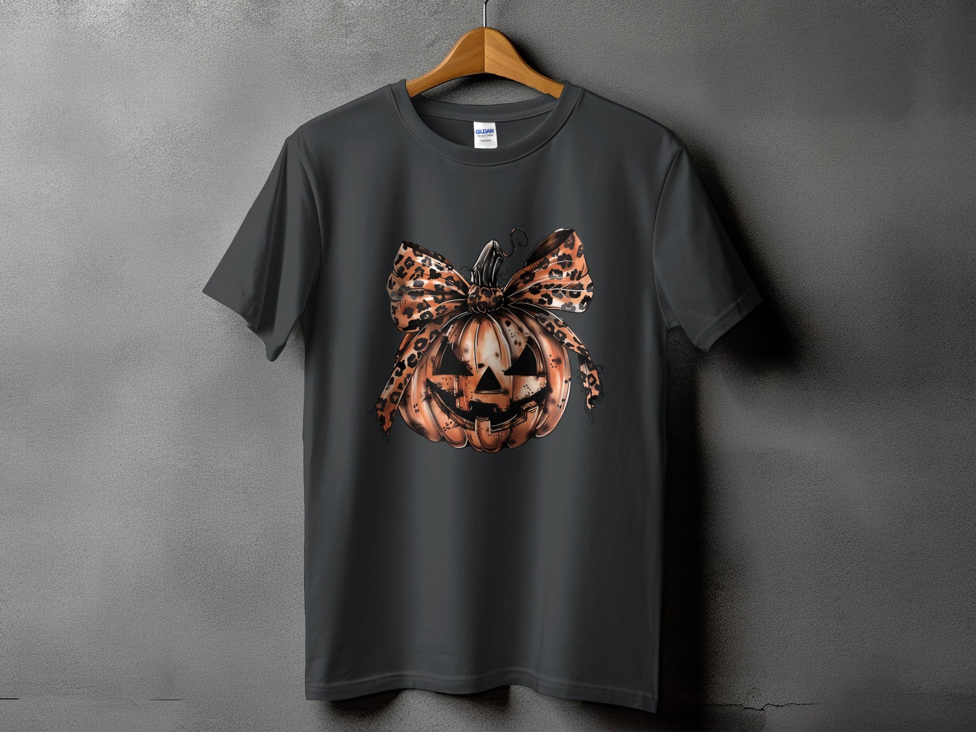 Dark gray t-shirt with a Halloween pumpkin graphic and leopard print bow.