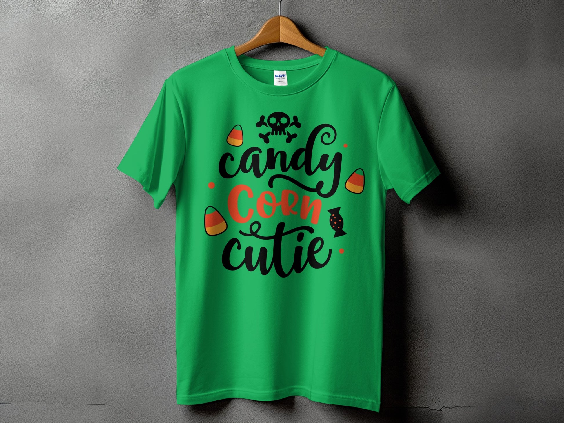 Green t-shirt with "candy corn cutie" text and Halloween graphics.