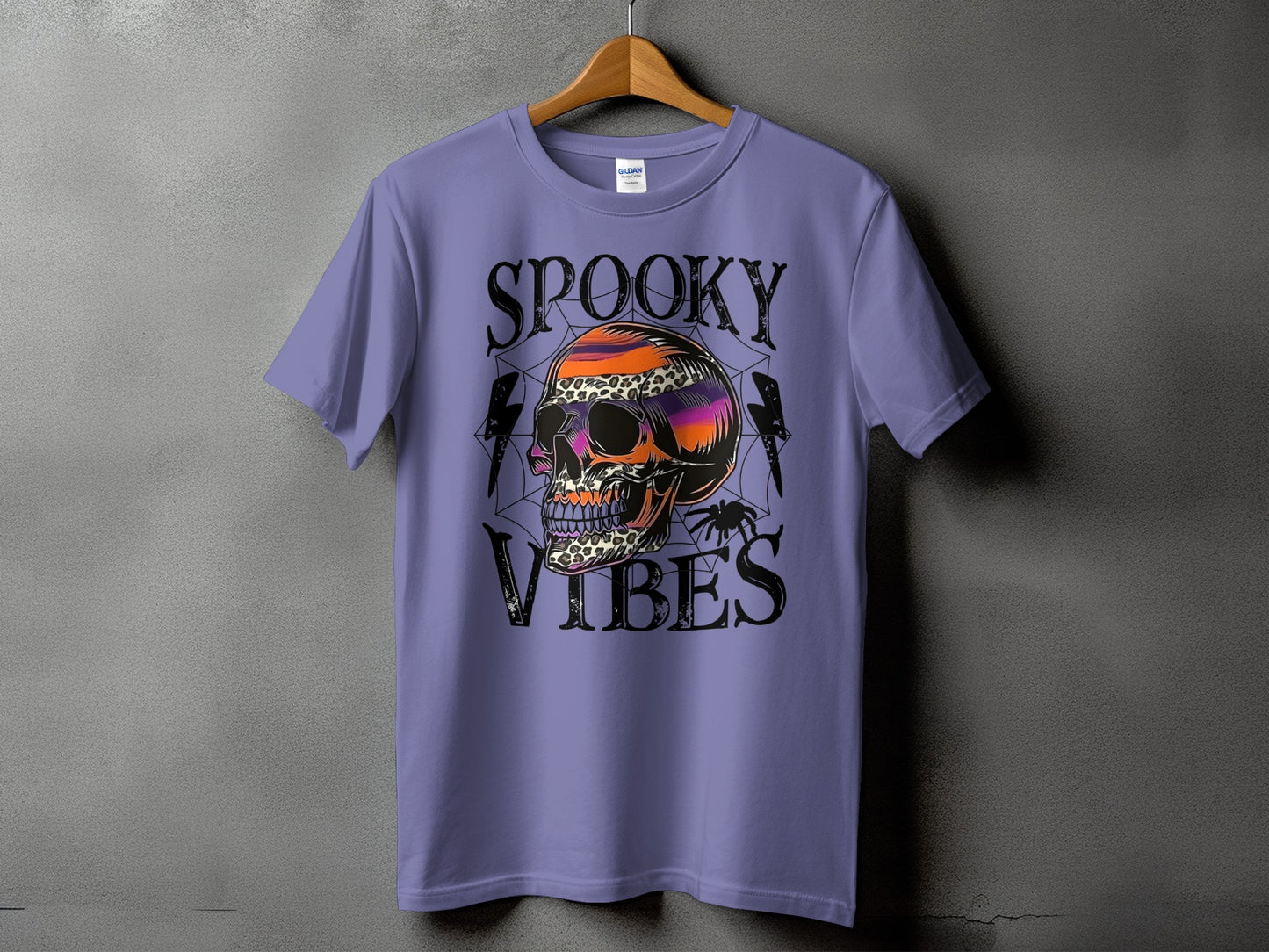Purple t-shirt with "Spooky Vibes" text and a colorful skull graphic.
