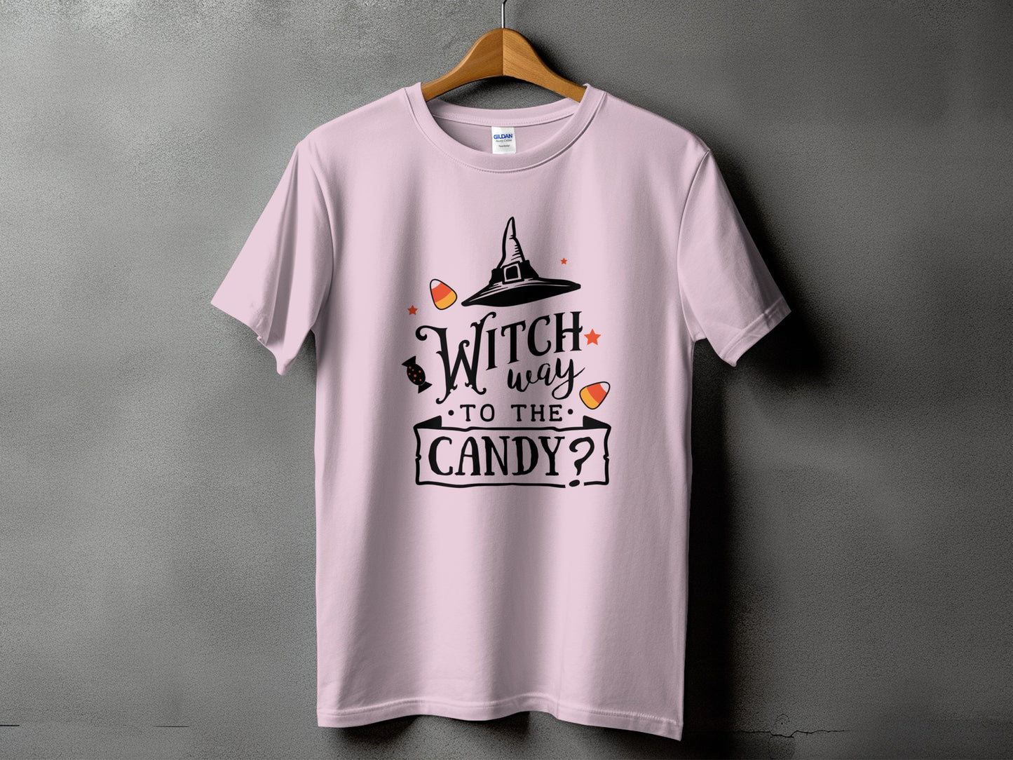 Pink t-shirt with text "Witch way to the candy?" and Halloween graphics.