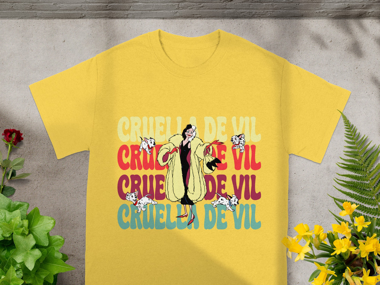 Yellow t-shirt with "Cruella De Vil" text and cartoon dogs.