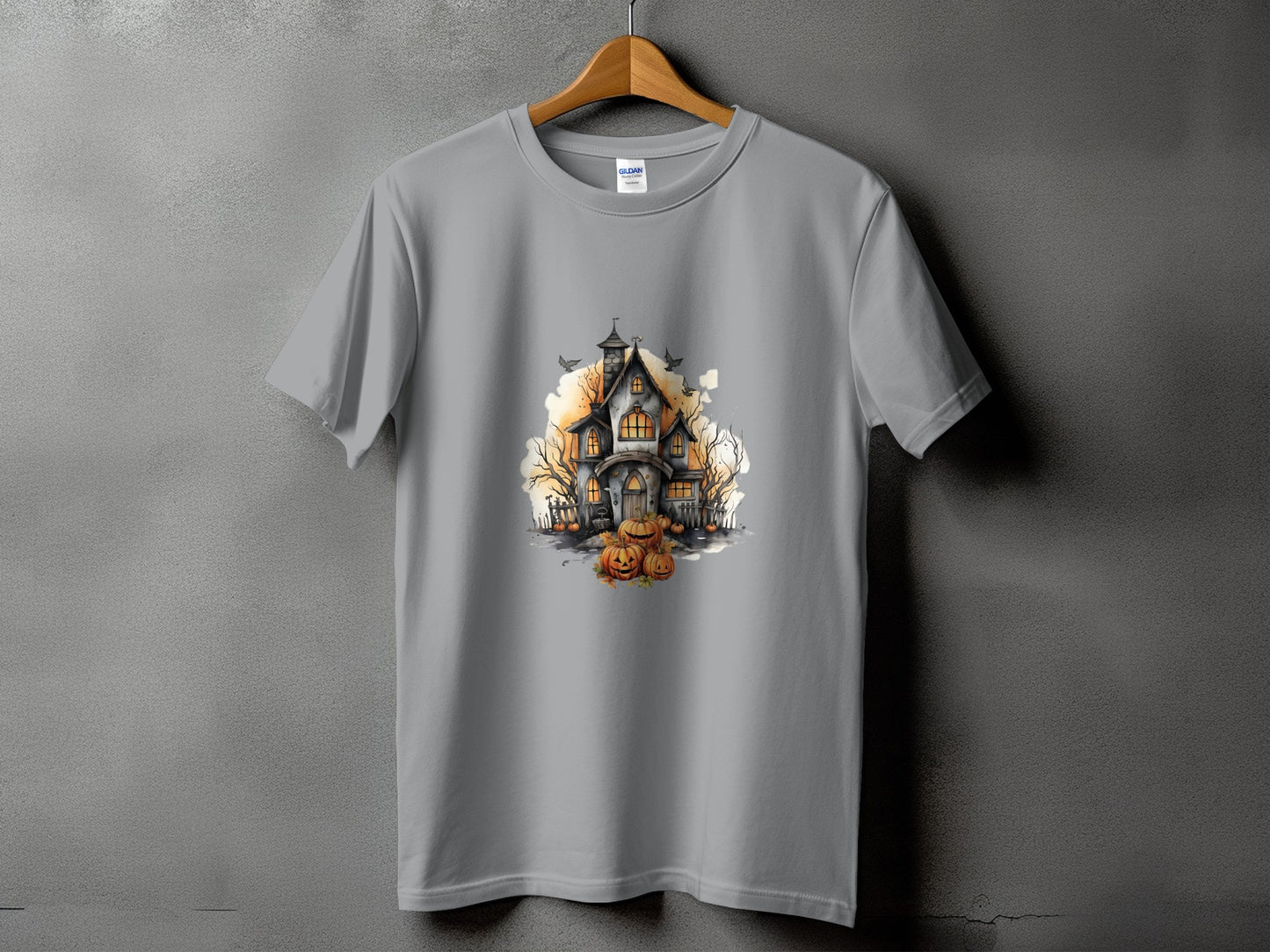 Gray t-shirt with a watercolor haunted house and pumpkins graphic.