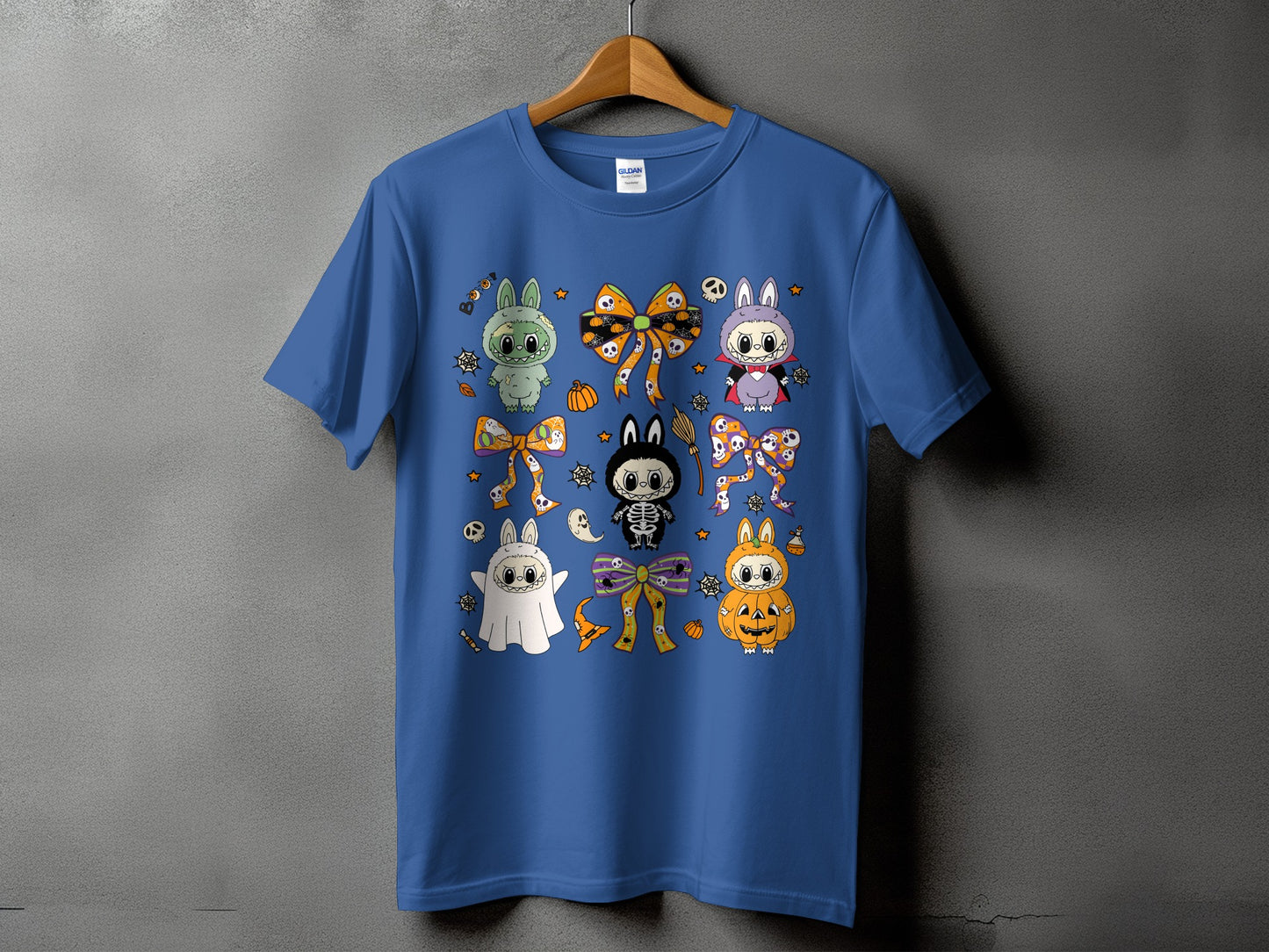 Blue t-shirt with Halloween-themed cartoon bunnies, ghost, skeleton, and pumpkin designs.