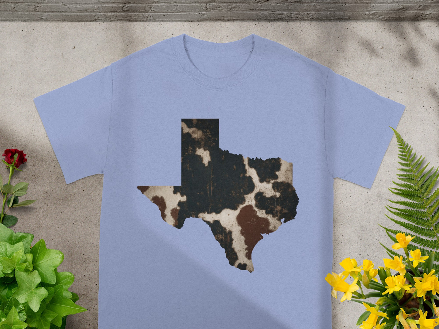 Light blue t-shirt with a distressed Texas map graphic in cowhide print.