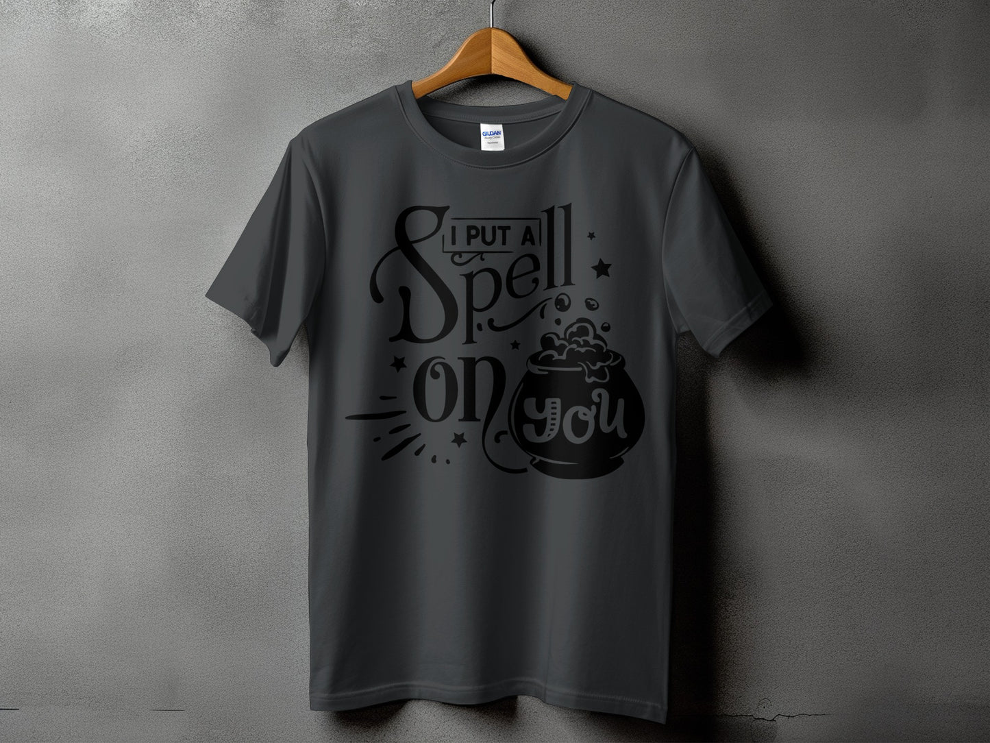 Dark gray t-shirt with "I PUT A Spell on you" text and cauldron graphic.
